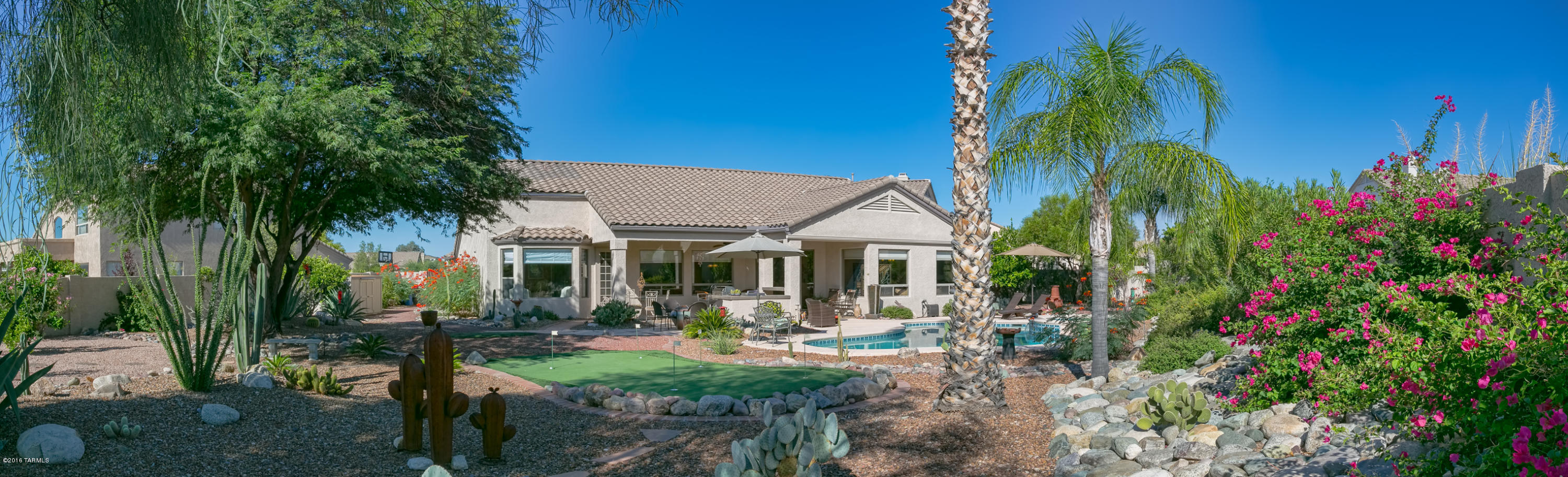 Updated Sunset Ridge with backyard oasis! Completely landscaped with plenty of trees, cactus, and flowering plants. This is the largest lot in the neighborhood at .37 acres. (Buyers to verify all square footage that is provided as a courtesy based on assessors records) All poly pipes replaced. All floors are tile including outside entry and covered patio. NO CARPET! All granite counter tops and stainless steel appliances. Bathrooms recently upgraded to include walk-in showers, new bathtub, sinks, plumbing fixtures and mirrors. Even a chandelier over the master bath tub. Fairly new outdoor kitchen with top of the line equipment. Enjoy the morning sun and mountain views and afternoon shade form your east facing backyard. Heated pool and spa with automated controls, and putting/chipping green Epoxy floor in garage with built-in storage cabinets. This property is NOT for rent.