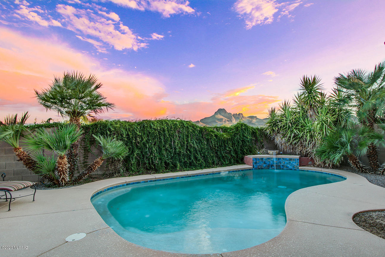 Stunning 4 bedroom contemporary with magnificent mountain views and cool, sparkling backyard pool w/waterfall!  Great architectural details & special features including: huge picture windows in the great room, arched doorways, open dining area, modern kitchen with quartz counters, tile backsplash & stainless appliances, peaceful master retreat with xtra large bay window, master bathroom w/luxurious garden tub, split bedroom plan, blt in media ctr, 10 ft ceilings, hand textured walls, custom  interior paint & stone exterior accents! Seller replaced A/C, water heater & g/r opener! Tranquil backyard oasis w/panoramic Mtn views,  built in bbq, multiple patio areas
& situated in a premier community with parks, schools, restaurants, bike lanes, skate park, pools/spa, tennis, shopping & much mor
