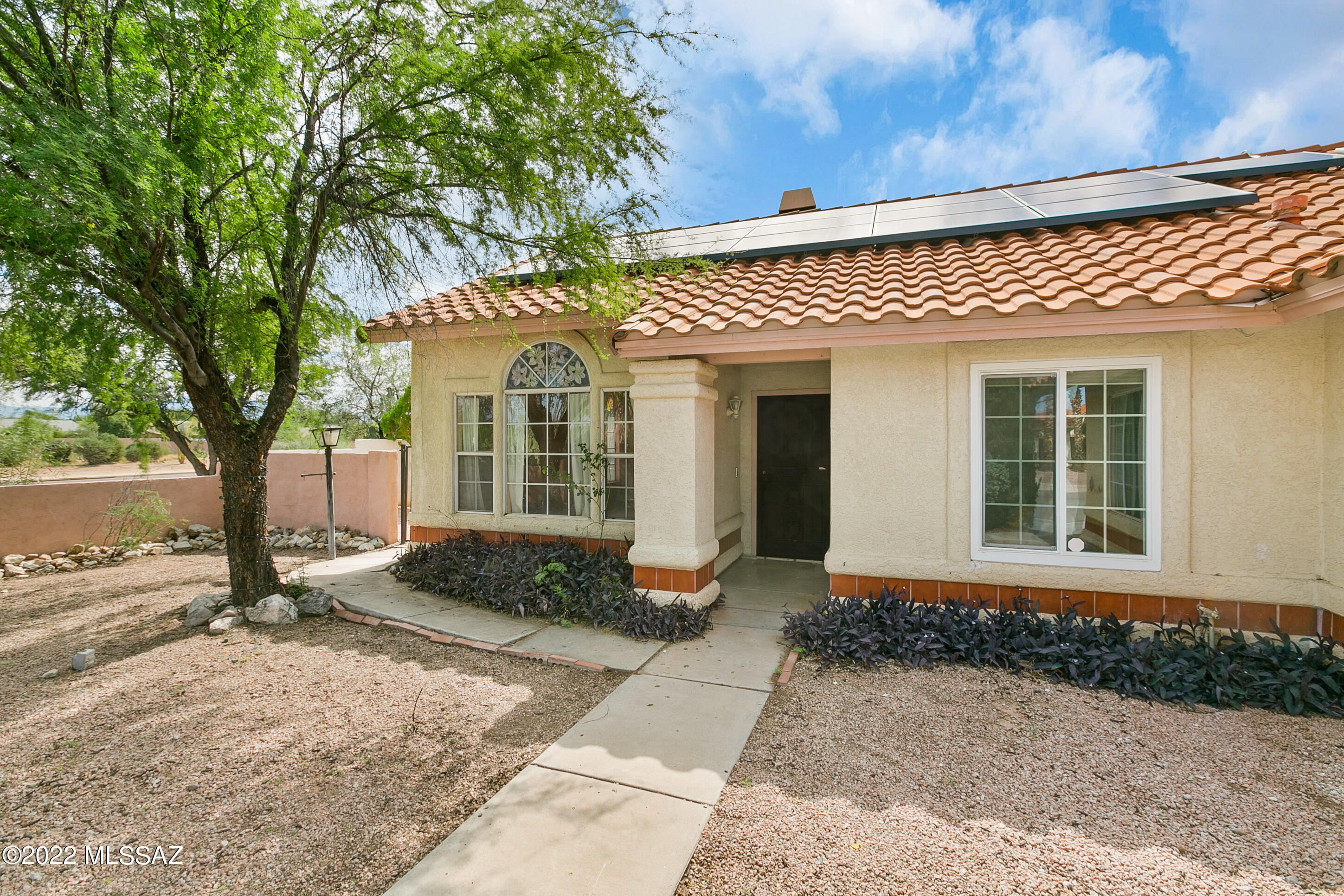 Sellers are offering up to 3% in concessions! New carpet in the bedrooms being installed on 12/13! Home needs some TLC. Beautiful 3 bedroom, 2 bathroom home on a corner lot nestled in Rita Ranch! No HOA! The front room features a fire place to cozy up to in the winter with fans in all of the right places to keep you cool in the summer. The kitchen features stainless steel and black appliances, a skylight, and custom banquette for dining. The spacious laundry room comes with built in cabinets. The pool house adds extra space for what ever you desire. The large back yard features a covered patio, fenced in refreshing pool, and an outdoor fireplace!  It's also in a great school district! The solar panels are leased and transferable. You don't want to miss out on this location or this home