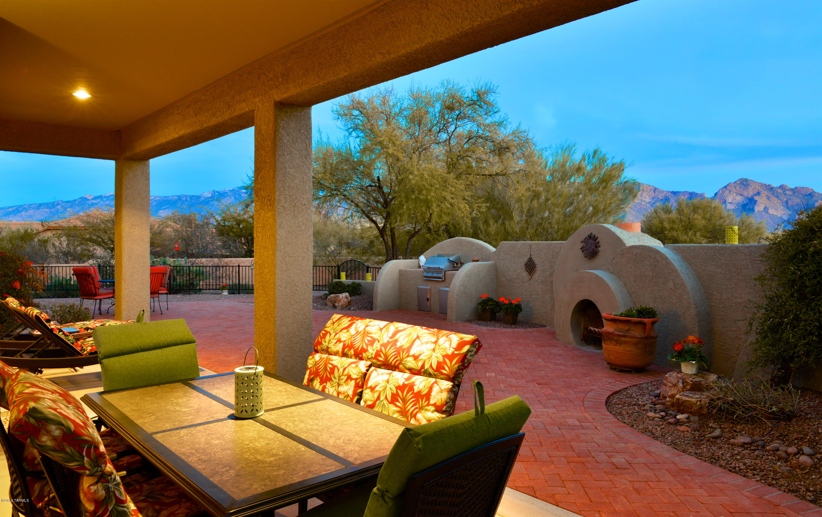 Stunning Catalina Mountain Views in Desirable Oro Valley Neighborhood. Home is on a quiet Cul- De- Sac with an Extended Driveway. You will Enjoy this Functional Floor-plan with the Bright & Open Kitchen w/ Cozy Breakfast Nook, Island, Upgraded Hickory Cabinets, Tile Counter Tops & Back-splashes. Kitchen Opens to Cozy Family Room w/ Eye Catching Gas Fireplace & Wall of Windows Exposing Breathtaking Views. Large Luxurious Master Suite has Double Entry Doors, Bay Windows with Mountain Views, Relaxing Soaking Tub, Separate Vanities, Glass Shower & Walk in Closets. Gorgeous Backyard has City Views, Large Covered, Extended Brick Patio, Additional Sitting Area, Built in BBQ, Amazing Rounded Fireplace & Panoramic Mountain Views. This Yard is Perfect for Entertaining Guest or just Relaxing after a long day. Property Extends Past Gate & has Mature Desert Landscaping Offering Tons of Privacy. Home also Features 10 Foot Ceilings Throughout, 18'' Custom Tile Flooring, Professional Paint, Large Office/Den, Powder Room & Elegant Formal Dining Room. Laundry Room has Hickory Cabinets with Sink & Extra Deep 3 Car Garage with Windows. Home has been very well kept. Must see today.