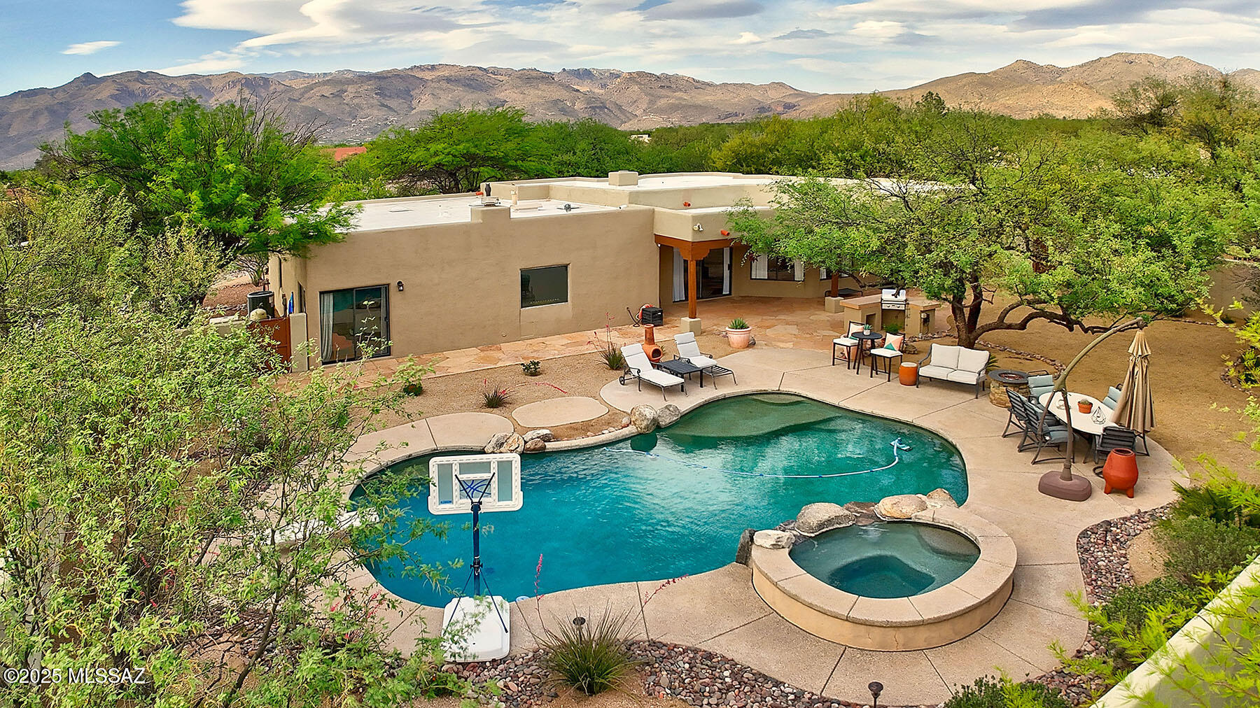 This stunning Santa Fe-style home sits on a spacious .81-acre lot at the end of a cul-de-sac. With 2,424 SqFt, the 4BR/2BA home offers a bright open floor plan with a formal living room, formal dining room, and chef's kitchen adjoining the family room, plus there's a large primary suite with walk-in closet. Enjoy excellent Catalina & Rincon Mountain views, a heated pebble-tec pool/spa, a built-in BBQ & a fire pit for perfect outdoor living. Located in the sought-after Tanque Verde School District. Near Forty-Niner and AZ National golf courses, Saguaro Nat'l Park East, Agua Caliente Park, & many hiking/riding trails. Relax & entertain with ease in this beautifully maintained desert oasis near the base of Mt. Lemmon. No HOA & the Polybutylene pipes have been replaced. THE PROPERTY
> Gorgeous Mountain Views
> San Domingo Subdivision
> No HOA
> Santa Fe Style Home on .81 Acre
> Well-Maintained Property
> Tanque Verde School District
> Located Near the Base of Mt. Lemmon, Saguaro National Park East, Agua Caliente Park, Forty-Niner and AZ National Golf Courses, and many Hiking/Riding Trails
> Paved Circular Driveway
> End of Cul-De-Sac Lot

THE HOME 
> Catalina and Rincon Mountain Views 
> 2,424 Square Feet
> Lots of Natural Light
> 4 Bedrooms and 2 Bathrooms
> Primary Suite with Spacious Walk-in Closet
> Saltillo Tile Floors
> Heated, Pebble-Tec Pool & Spa
> Built-in BBQ
> Flagstone Patios
> Fire Pit
> 2-Car Garage 
> Newer HVAC System
> Polybutylene Pipes Replaced