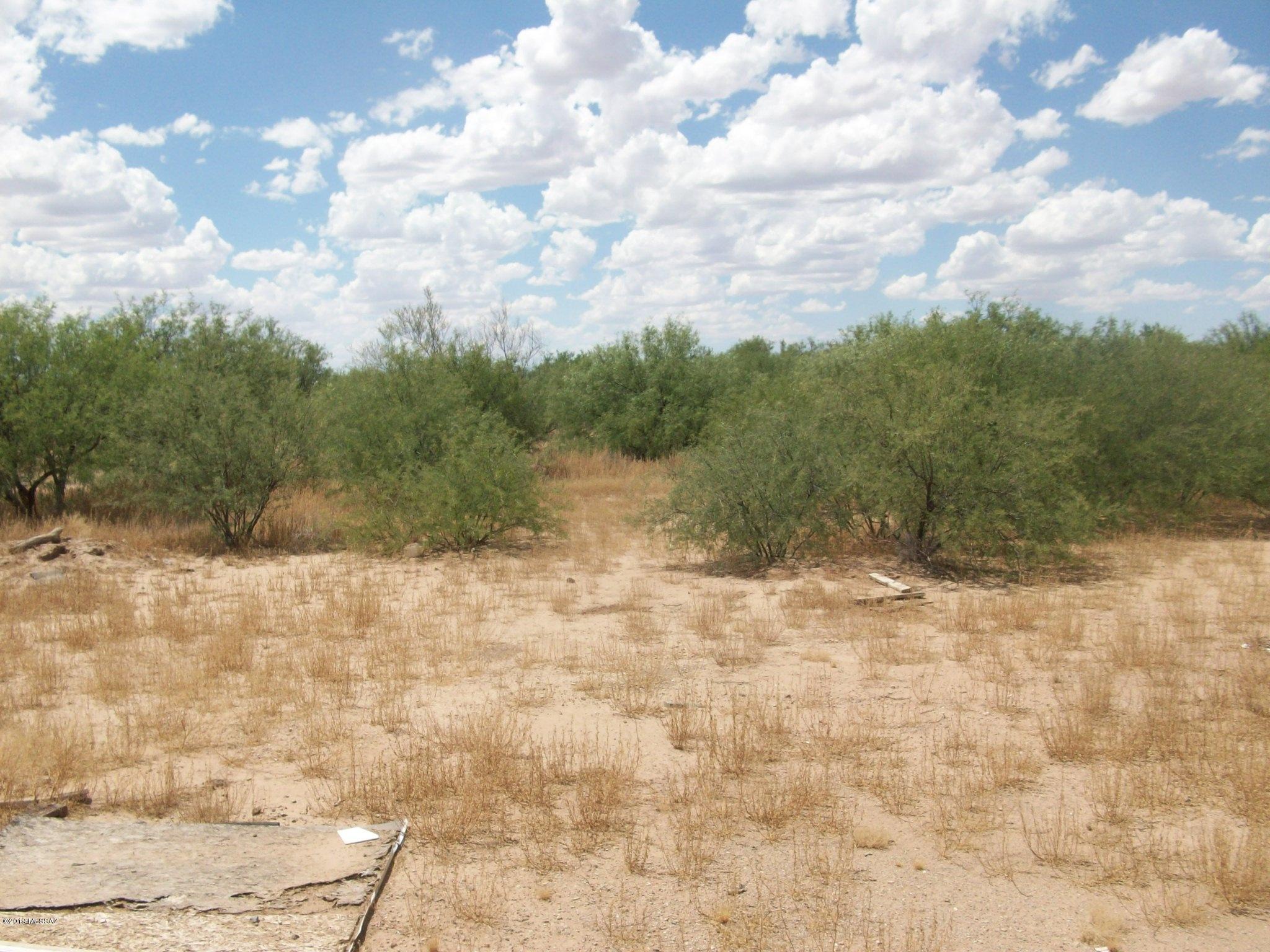 Level four acres with raised area where a manufactured home had been - septic connection and cleanout present as is electric stand (damaged) and water source - potentially well on parcel to the north (needs verification) - clean up that area and install a new home.