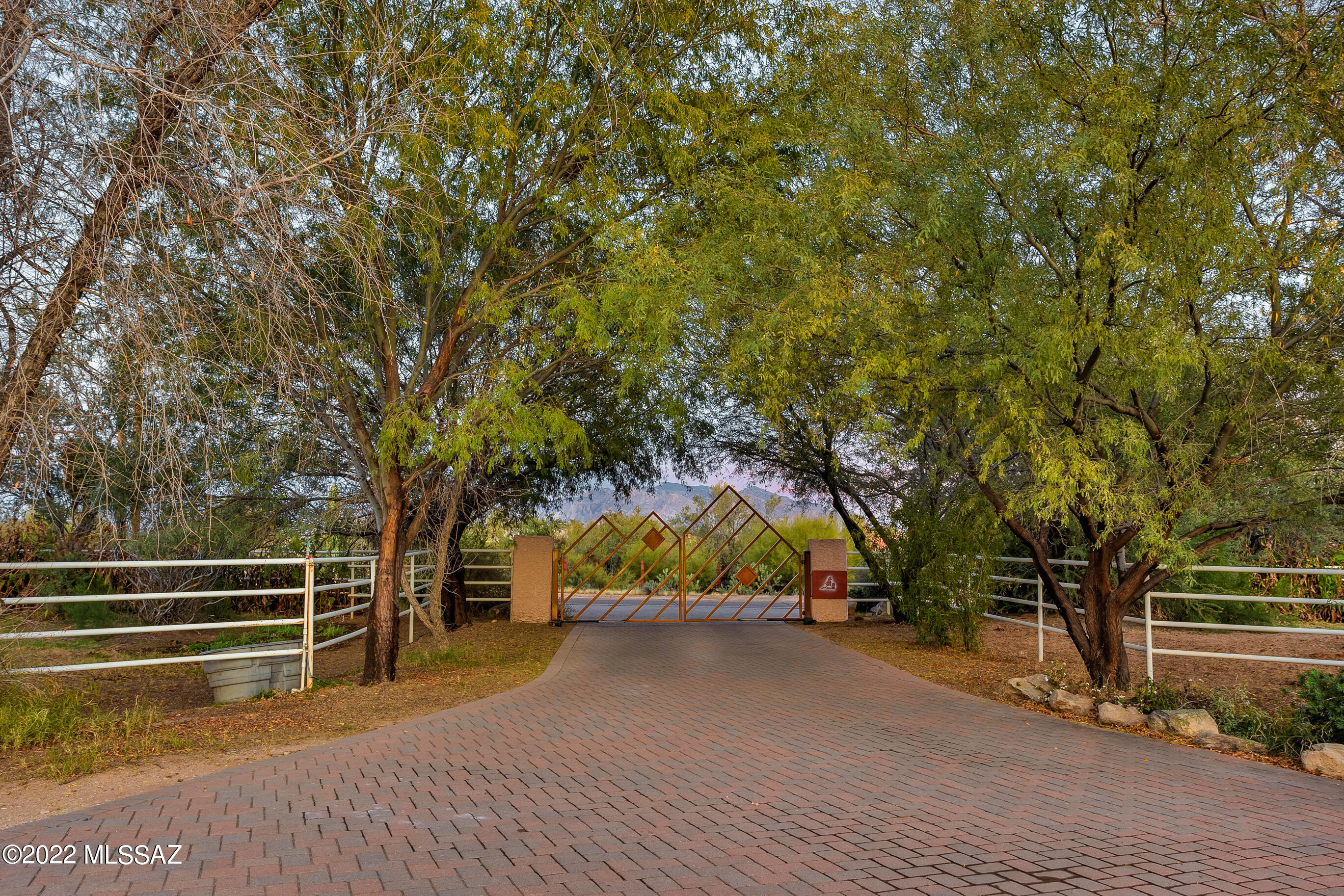 This gorgeous working ranch is nestled on nearly 5 acres. Horse property, NO HOA, with several corrals, hotwalker, round pin, arena, mare motel with lighting and shade for the horses. Hay barn, several grazing pastures, two tack rooms for storage and much much more. The home is elevated and set with a grand entrance of double gates, pavers that host the drive up to the front entry of the house and three car oversized garage. Back patio boasts panoramic Mountain Views that show both sunset and sunrise. 4 beds, 3 1/2 baths, guest quarters with separate exterior private entrance, jack and jill bath for the two spare bedrooms & guest powder room. The vaulted ceilings give a grand feel when you walk through the double doors to enter the home. This property is a must see!