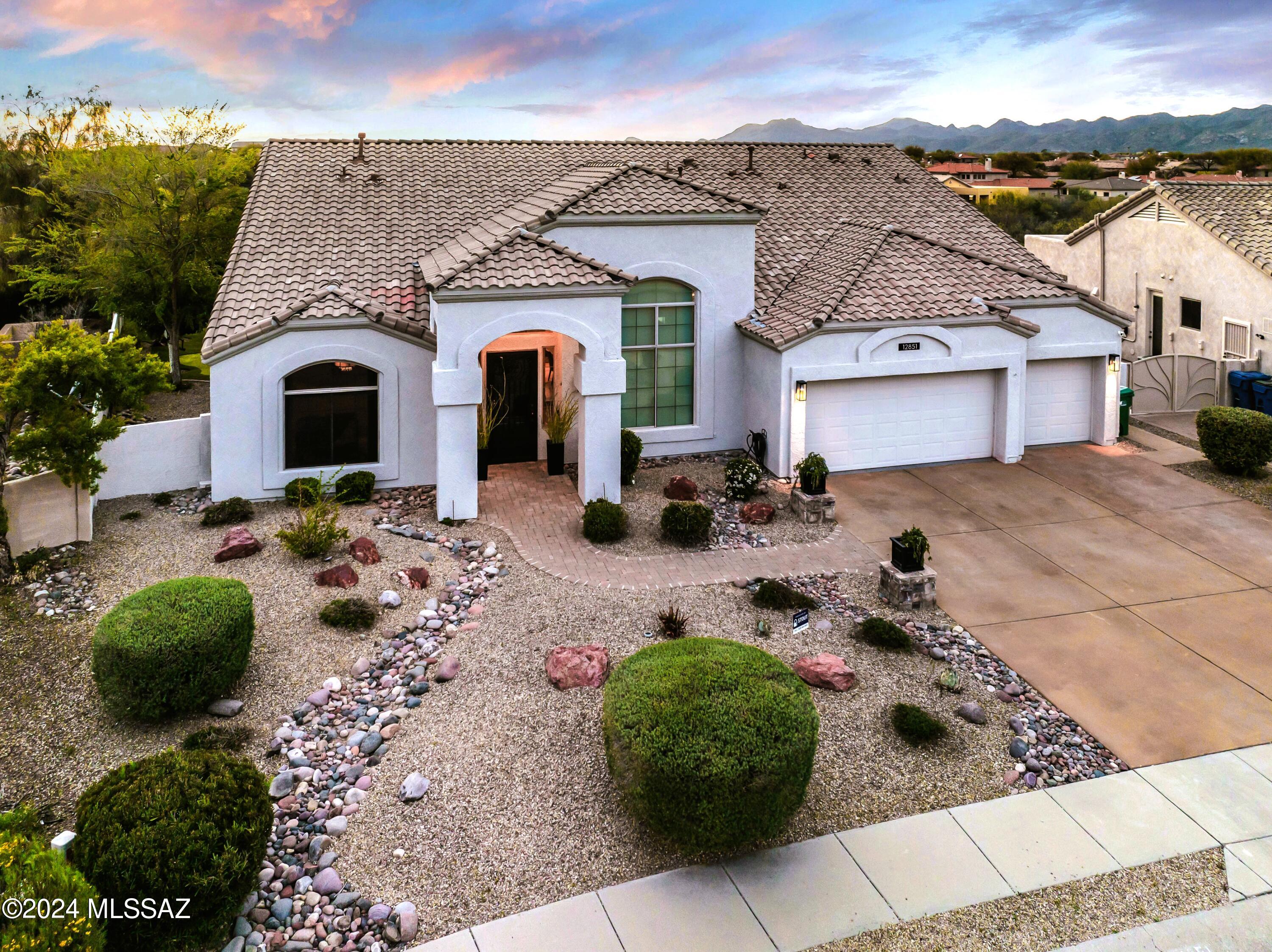 Discover the perfect fusion of style & function in this Warm Contemporary Beautiful Oro Valley Oasis. Every detail has been thoughtfully crafted to elevate your living experience.  Arizona sunsets, Tortolita Mountain and Sonoran Desert views are the backdrop for this exceptional residence offering a blend of Old-World charm and modern amenities. The heart of the home is the gourmet kitchen featuring Quartz counters, stainless steel appliances, and an expansive island with built-in beverage fridge & microwave. The island is the focal point for gatherings while providing ample space for meal prep. Flowing seamlessly from the kitchen is the Great Room with 16' ceilings, Formal Dining, a Cozy Bar with seating for four, and a Charming Gas Fireplace. Step outside under the massive covered porch which overlooks the heated pool & spa for year-round enjoyment, a built-in barbecue grill, and a wood-burning fireplace and seating area. Newly installed premium easy-care turf, putting green, fountain and mature citrus trees provide for a truly peaceful setting for the many months of Arizona outdoor living. The home is also wired for sound in various zones including the patio with 8 speakers evenly spaced along the roof of the entire patio with convenient outdoor volume controls.  The property is situated at the end of a quiet cul-de-sac with no neighbor behind you facilitating views of the sky, stars, mountains, and lush natural desert vegetation. Please note that there is an expansive window in the front living room with gorgeous views of Pusch Ridge from inside the home (Great Room, Entry, Dining Area).  The owner has also upgraded and improved the property with the following core necessities making the residence truly "move-in ready".  New tile roof! 2 new top-of-the line Lennox Signature Collection HVAC units! New high-efficiency pool pump!