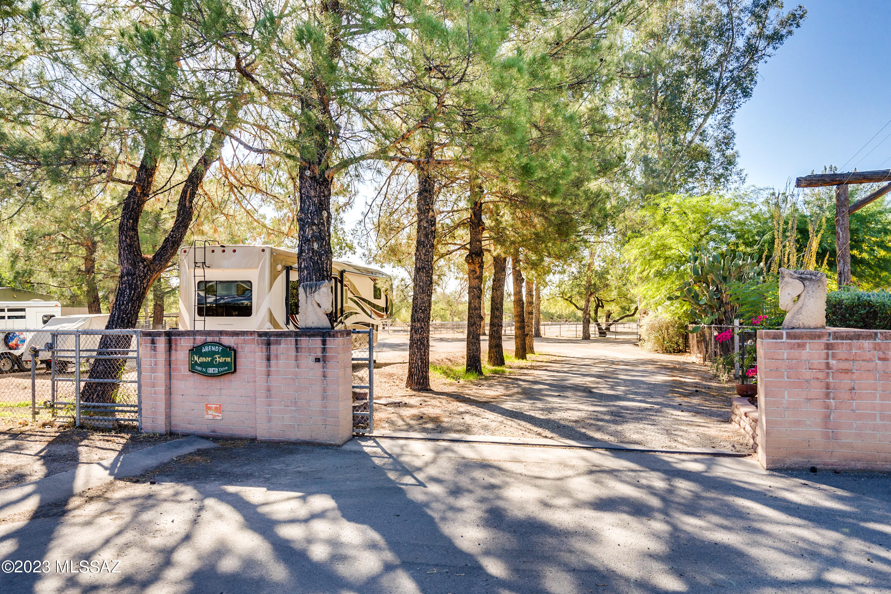 Equestrian's paradise! Exclusive and rarely available. Just under 5 acres! Large arena, pastures, private well, 9 stall barn with tack room (and bathroom), washer/dryer, hot & cold water, feed room, wash rack, hot walker and round pen. This home offers a seamless blend of comfort and equestrian amenities. Enjoy the perfect balance of country living, privacy, and modern convenience to shopping and dining a short drive away! The home features 4 bedrooms, 4 bathrooms, AZ room with a sink and bar, 3 car garage with workshop, and a large kitchen with plenty of storage! Huge cottonwood, pine and mesquite trees create a park like setting. Trails for biking and horseback riding a short walk away! Zoning allows for multiple dwellings, would make a great family compound! Seller financing available Metro water AND well water.