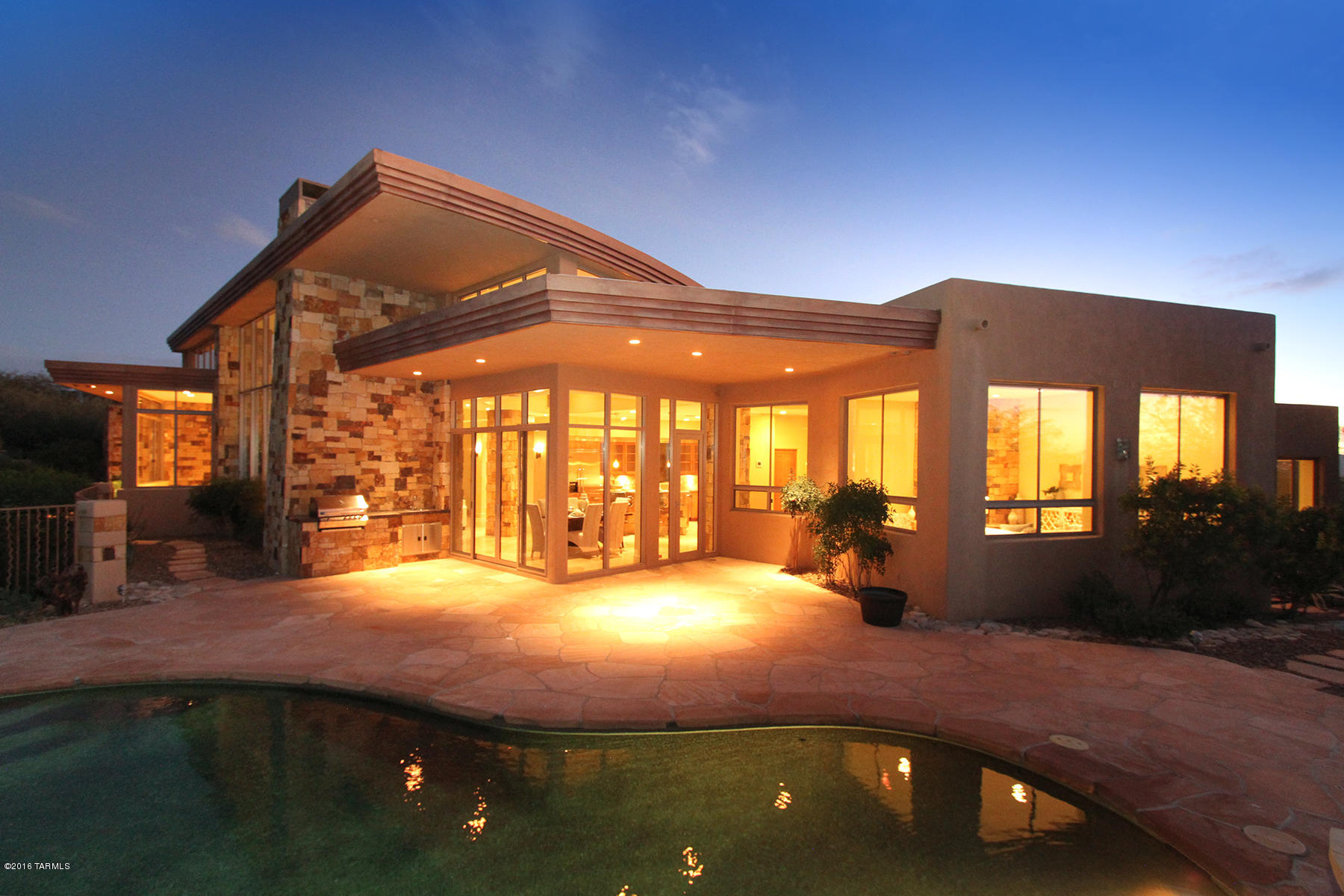 This stunning contemporary home located in prestigious Pima Canyon Estates is now available for the discerning Buyer. Designed by architect William Gansline  and sited to enjoy spectacular panoramic views of the Catalina Mountains through floor to ceiling windows.  Showcasing the following accoutrements: 3 bedroom+den w/open split floor plan, gourmet kitchen w/granite counters, cherry wood cabinetry & Viking appliances. Additional features are 24'' travertine floors,stone FP's, 8ft. knotty alder doors throughout & spacious private master suite and bath.  Entertain family & friends in resort-like backyard with pool,spa, firepit & built-in BBQ.