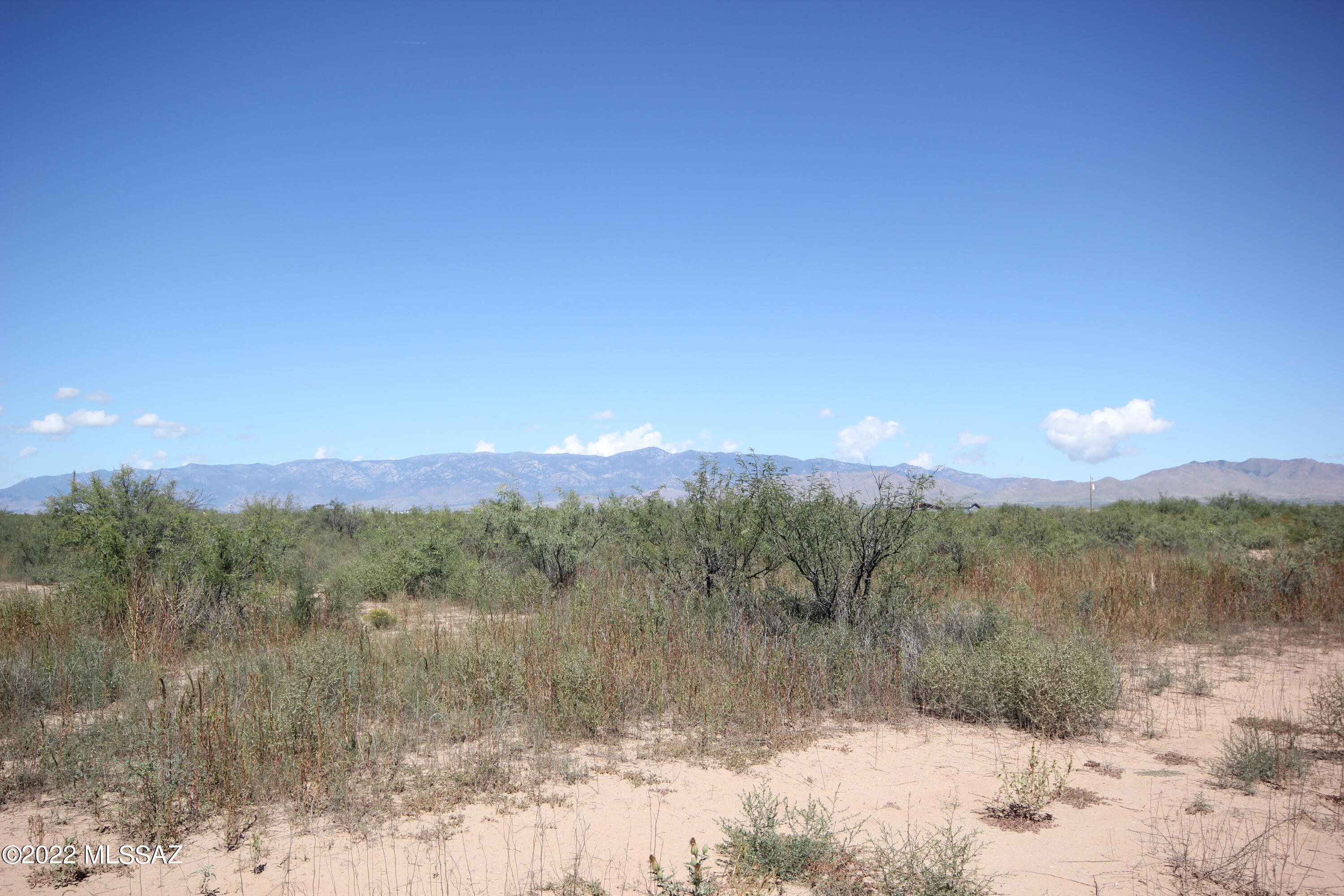 Private, quiet, flat, vegetated lot with panoramic views. There are a few neighbors, some doing agriculture. Only a short distance from the main paved road for Fort Grant.  Make this lot your own and realize your dream of rural living.