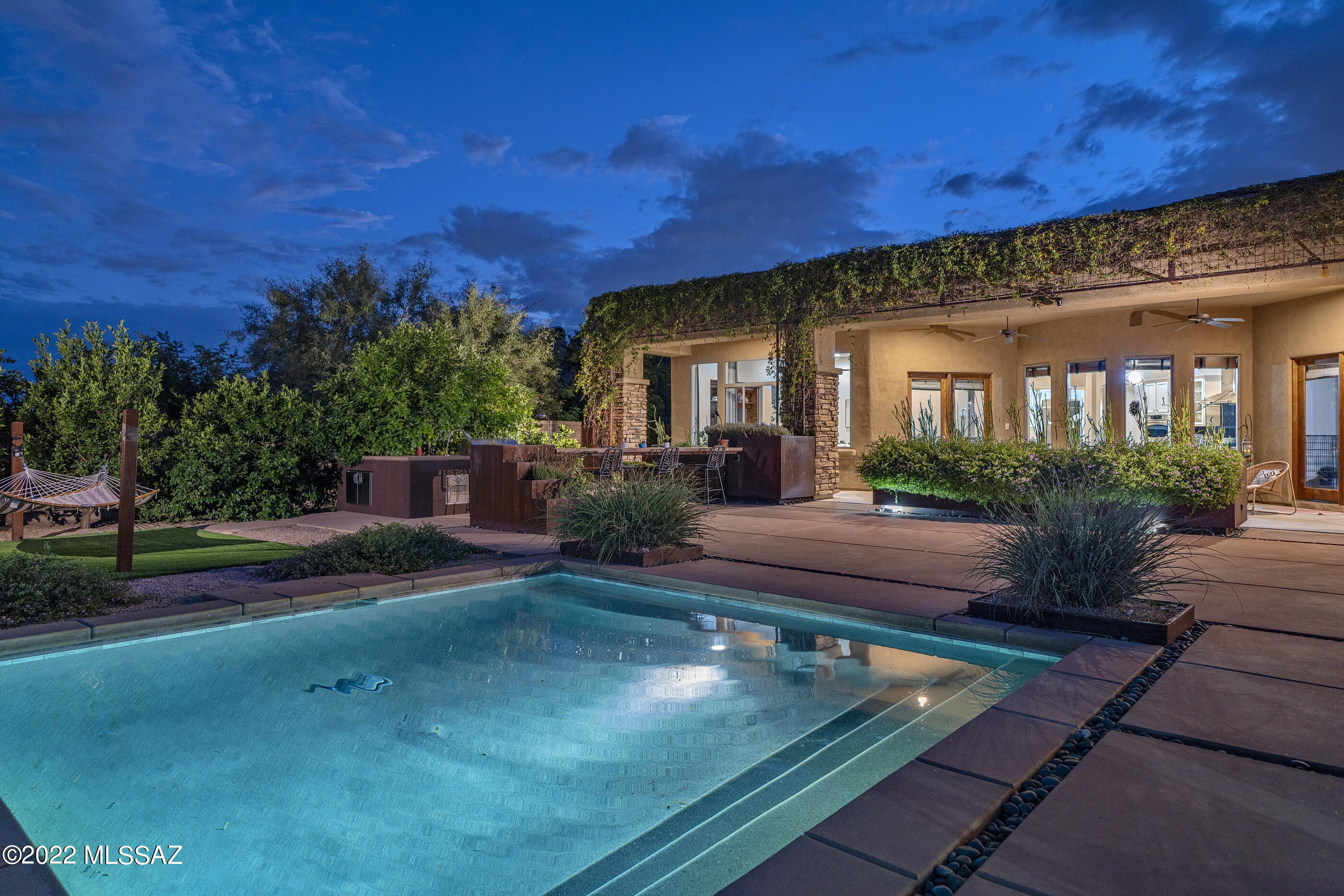 Enjoy the dramatic and unobstructed mountain views and natural desert landscapes from this privately situated AF Sterling built home, located in the highly desirable gated community of Ventana Reserve. Offering an open, bright and airy split bedroom floor plan, featuring 4,631 sq ft, four bedrooms and four baths, with interior spaces that range from open and soaring, to cozy and intimate, taking full advantage of natural light, blurring the boundaries between the interior and exterior spaces. Soft rounded corners with walls of glass allow the resplendent interiors to expand outward encompassing the sweeping view corridors framing the Catalina Mountains. Upon entry, you are greeted by the central hall establishing the main connection point of the home, with Travertine flooring that... floats seamlessly throughout the space, providing a subtle contrast to the warm exposed wood tones and textures. The heart of the home is the fabulous Chef's kitchen with gorgeous finishes throughout, including crisp white custom cabinetry, complemented by granite countertops and sleek chrome door pulls with top-end appliances. The exquisite custom-tailored breakfast bar features an array of service counter space, acting as a focal point in this kitchen of range and proportion, with the breakfast dinette opening onto a spacious family/living room, creating a highly interactive space.

Sequestered on the primary level of the residence is the owner's suite, complete with a patio walkout and luxurious primary bath, with dual vanities, walk-in shower, large soaking tub and oversized dual dressing closets. Three additional secondary suites, as well as a large media/flex room are featured on the upper level of the home, privately situated and perfect for family, or guests alike.

The backyard, designed by the highly acclaimed REALM design firm and featured in Tucson Home & Garden magazine, offers a series of elevations and patios, with the exterior living spaces designed for year round outdoor entertainment. Located adjacent to the covered veranda is an outdoor kitchen, complete with a barbecue station and endless counter space, overlooking the sparkling pool and spa, while incorporating a fire pit perfectly designed to the home's effortless blend of laissez-faire. 

Every comfort is considered and detail meticulously crafted, the result being a home that offers a sense of ease to enjoy both the Tucson lifestyle and entertainment.