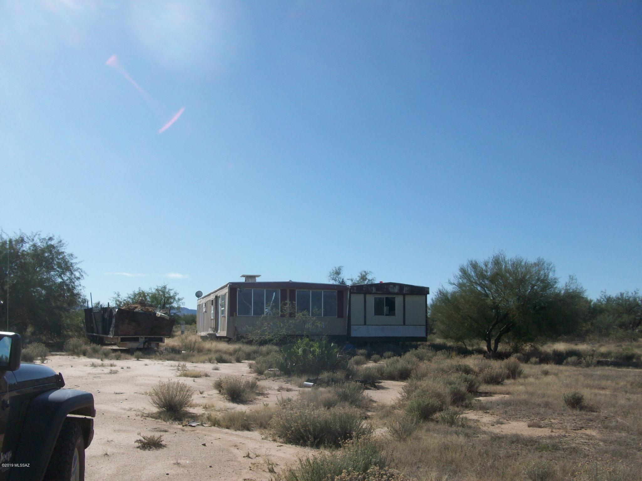Over an acre of level land in area of Manufactured home - Utilities on the property - city water, septic and electric stand - need work to be operable but, bargain priced for quick sale