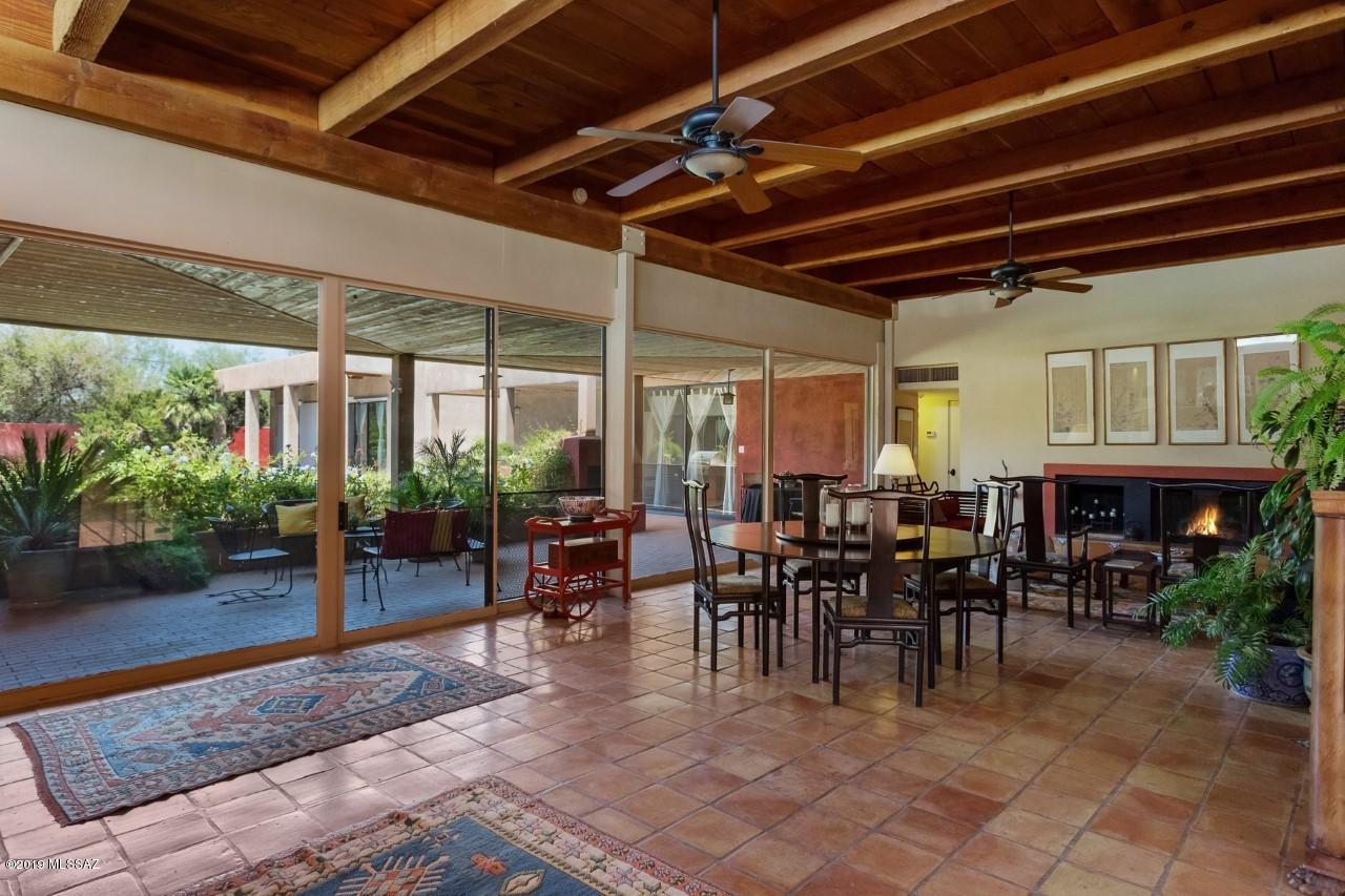 Nestled in the heart of Tucson, in the famed Colonia Solana neighborhood, this unique property offers quiet intimate spaces reminiscent of old world character.  Designed as a contemporary type Hacienda, it envelops private patios leading out of all the rooms and is highlighted by a large inviting pool. Front courtyard leads to the entry of an inviting great room featuring 12' plank and beam ceilings with warm fireplace and a wall of glass, integrating the lovely landscaping, patio and pool. St Charles kitchen, separate family room/library, and inviting master suite with pool views/access are just some of the highlights. Spacious GUEST HOUSE is equally charming and includes a 2 car carport. Especially attractive location for those that like to golf, walk, jog, play tennis or handball, this classic home located adjacent to Randolph Park, will invite you to be its next Owner. Home of a former Mayor.  
2956 sqft 3BR/3BA main house and 891 sqft 1BR/1BA Guest House. Excellent location and minutes to U of A, El Con Mall and downtown.