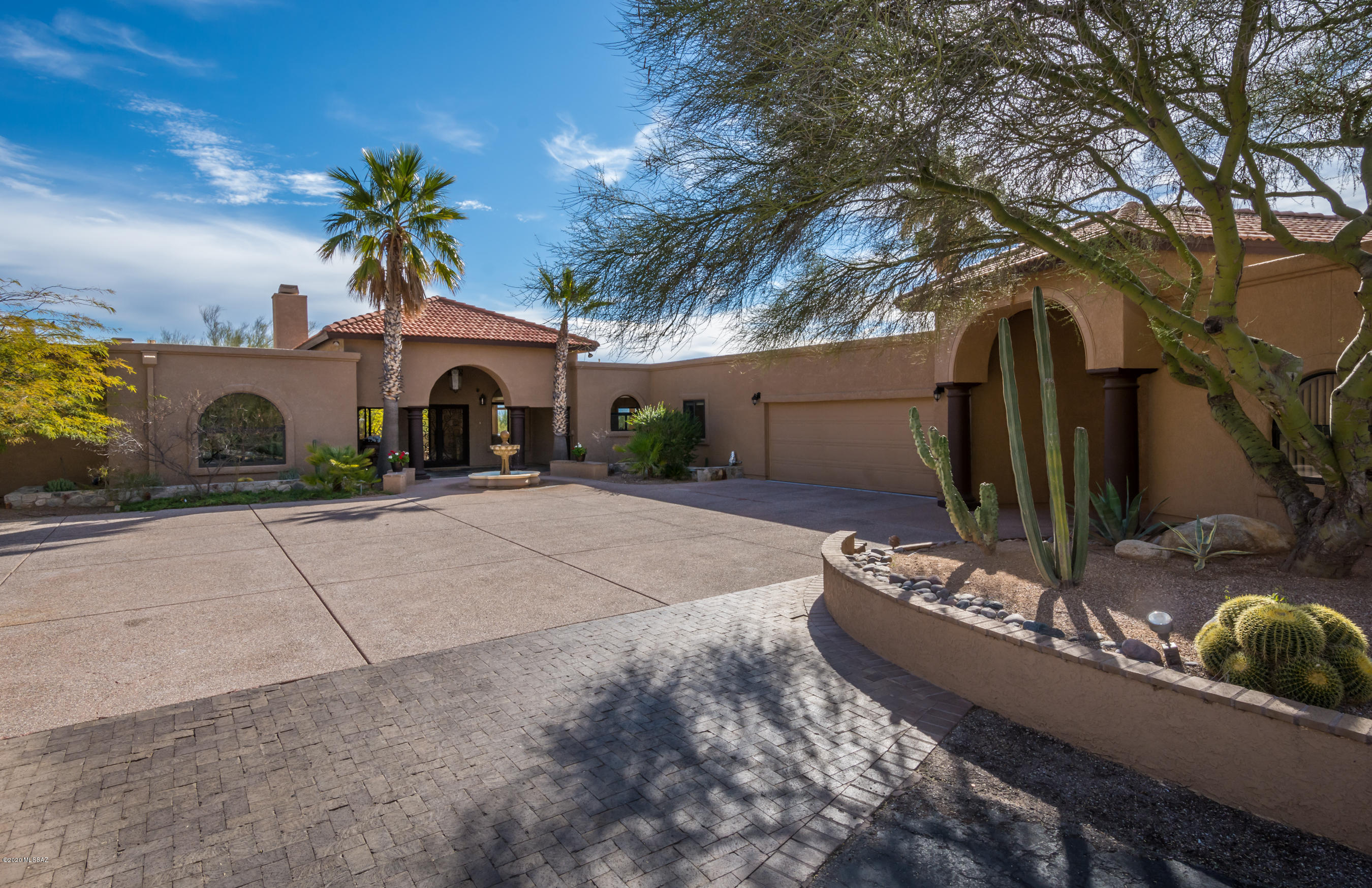 Beautifully appointed home in coveted Alta Vista Estates. Spacious open floor plan allows all living areas to flow together. The kitchen is a gourmet chef's delight with a 6 burner Decor gas range with double oven, enormous island, sub zero refridgerator, granite counters and breakfast bar overlooking the family room with built in bar and loads of cabinet space. Elegant living room with cantera stone fireplace. The entertaining area expands to the peaceful oasis outside with a outdoor kitchen, negative edge pool with spa that over looks the city and a putting green.  Master suite has a charming beehive fireplace, large walk in closet, sitting room, separate sinks in master bath, jetted soaking tub and dual headed shower. 3 additional bedrooms and two additional full bathrooms, 3 car garage with a porte couchere seperating the two car garage from a one car garage that could possibly be converted into a casita. Workshop is heated and cooled,  Central vac, alarm system, newer HVAC.  This home has been lovingly cared for and is full of charm and beauty.  Perfectly located with District 16 schools and close to fine restaurants and shopping.