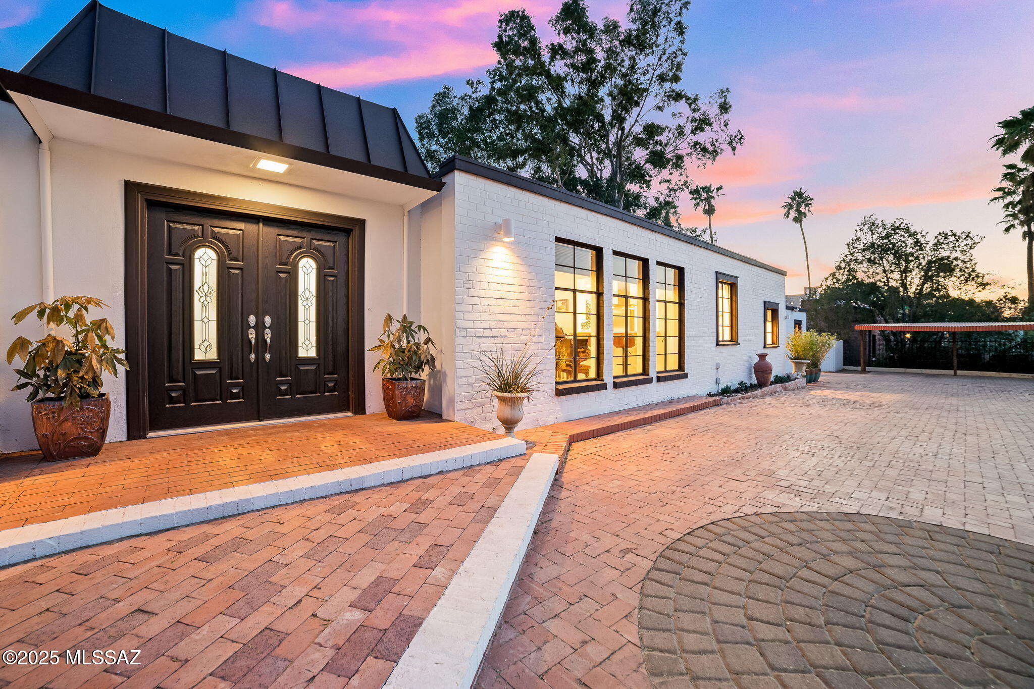 Seller to entertain/counter offers from $900k-$950k. Zen Retreat in Historic Blenman-Elm. Discover the allure of a meticulously remodeled mid-century modern masterpiece, boasting over $200k in luxurious upgrades that redefine elegance and comfort. This 2,489 sqft estate offers a free-flowing floor plan with a spacious great room featuring a cozy fireplace and abundant natural light. The gourmet kitchen boasts white cabinetry, quartz counters, and stainless steel appliances, perfect for culinary enthusiasts. The expansive owner's suite includes a beautifully appointed master bath with clawfoot bathtub, providing a serene retreat. Beyond the main residence, a one-bedroom guest house with private entrance, living room, kitchen, and bath offers an ideal rental opportunity or space for guests. The property showcases a circular driveway, a two-car garage, and a sparkling pool with an endless current system, all set amidst zen gardens and a tranquil water feature. Located just a short walk from Banner Hospital, the Arizona Inn, and the University of Arizona.