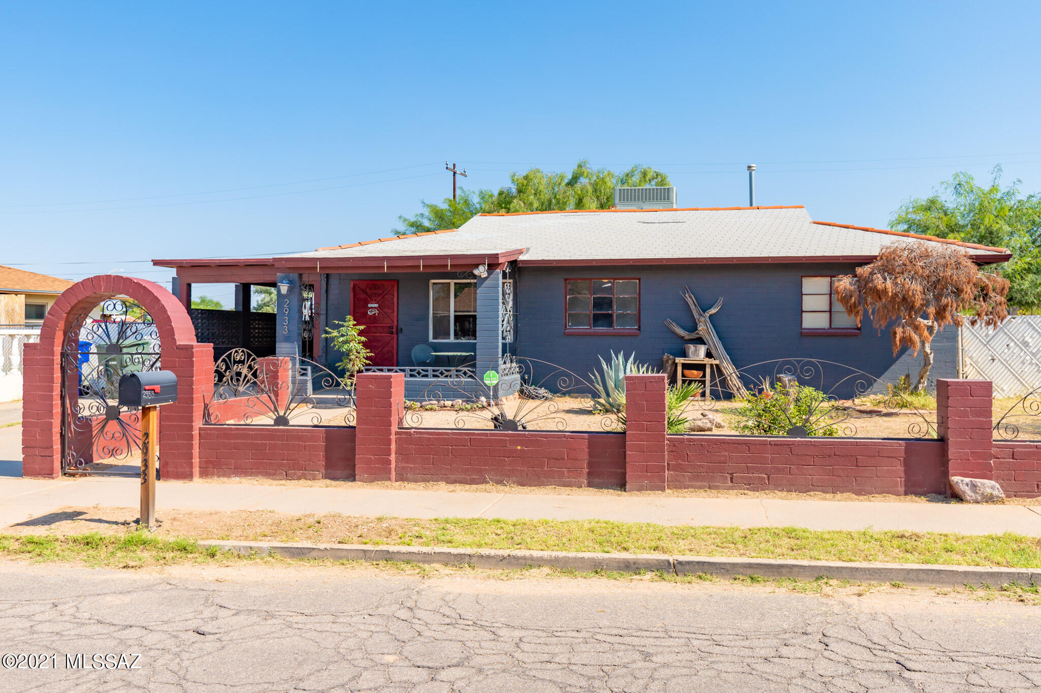 Adorable, fun and colorful 1950s bungalow in a great location - close to shopping, restaurants, downtown, and the UofA.  3 BD/2BA with nicely sized living room attached to library nook and dining area.  Big bonus room including washer and dryer.  Large covered patio with bar and storage unit included.  Backyard oasis complete with waterfall, Koi pond, deck and gazebo.  Lots of improvements and upgrades by the current owner.  Security system with alarm and cameras.   Electric box and grounding rods replaced in 2018.  Make this beautiful and charming home yours!