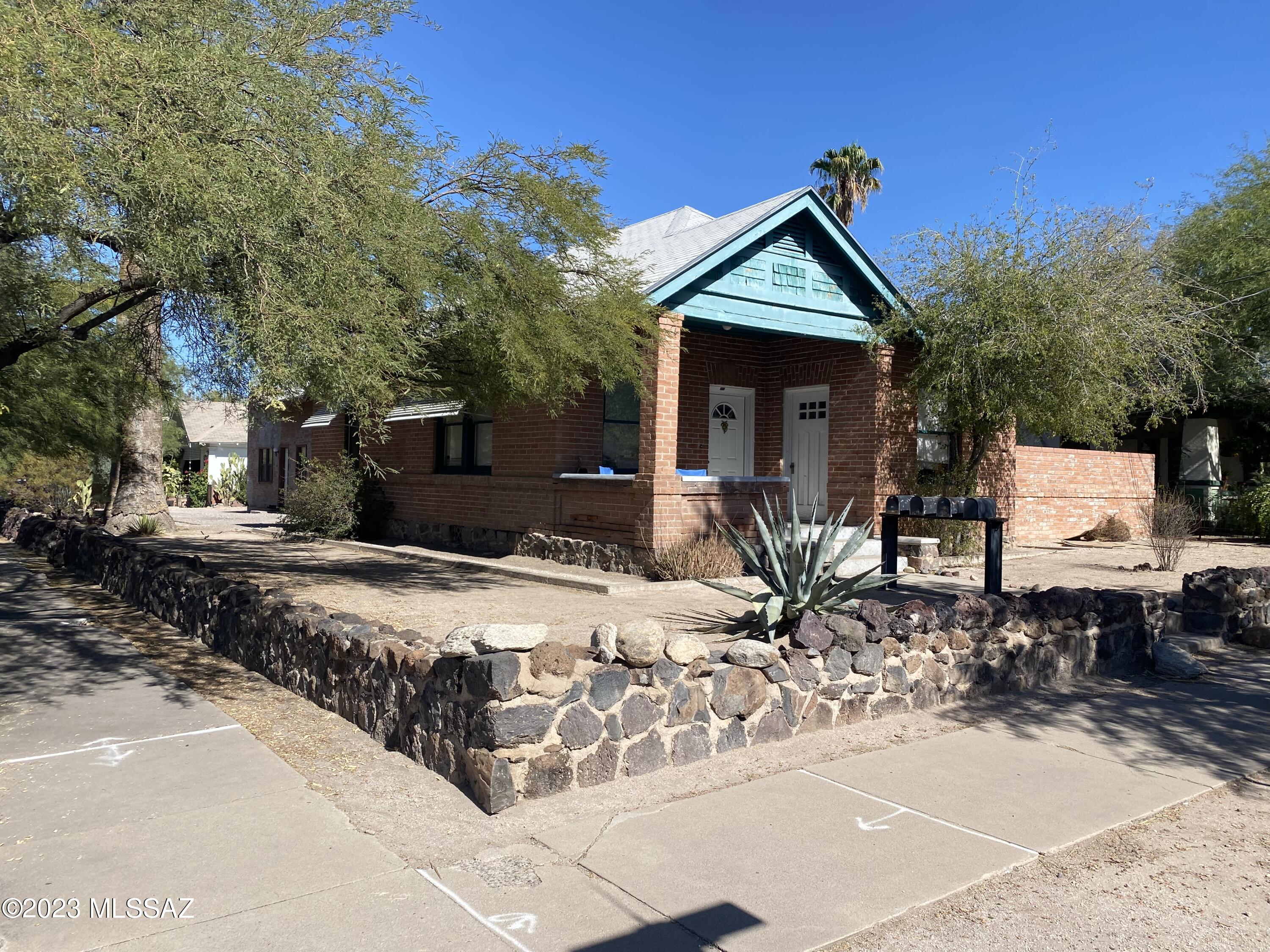 Close to the UofA & located in the West University Historic District! The main house is a super cute red brick home with historic charm including wood floors throughout and footed bathtub. AC cooling. Kitchen includes refrigerator and gas stove. Washer and dryer included (as-is). All ground floor units have private yards.
The three units behind the main house are addressed as 906 N 6th Ave. Units B & C have ceramic tile flooring, electric stoves and refrigerators. Unit C has vinyl & carpet flooring, electric stove and refrigerator. Photos used are before current tenants moved in. The property needs help to return to it's original charm. Perfect for a hands on owner.

Property is currently occupied. PLEASE DO NOT DISTURB CURRENT TENANTS! Units will be shown with an accepted offer.