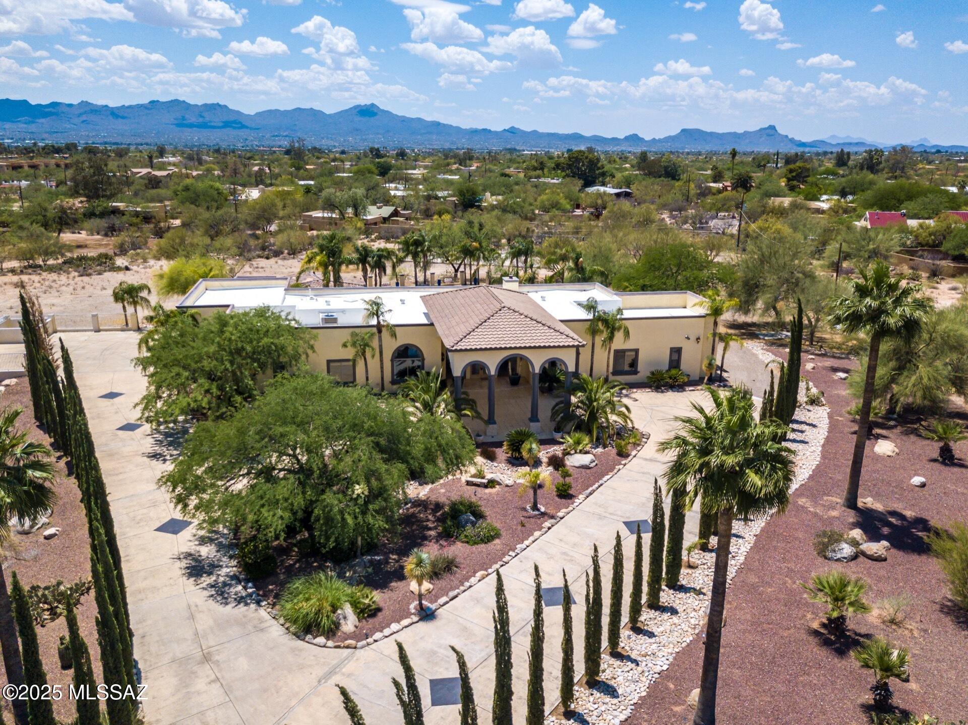 Property sold. This private oasis with a gated driveway entry sits on 3.46 sub-dividable acres with NO HOA. 5,082 sq ft main house w/ an 802 sq ft separate guest house. Open concept floor plan w/ split bedrooms. 5 bedrooms, 6.5 bathrooms, master suite has it's own wing w/ attached gym/office, 14' ceilings, travertine floors. Chef's kitchen features a large center island, granite counters, double ovens & high-end stainless steel appliances. The resort style backyard features sparkling salt water pool, spa, covered BBQ, paved patio & full bar. Full size basketball/tennis court. Fire suppression system, complete irrigation, dual water heaters, newer dual 5 ton AC's.