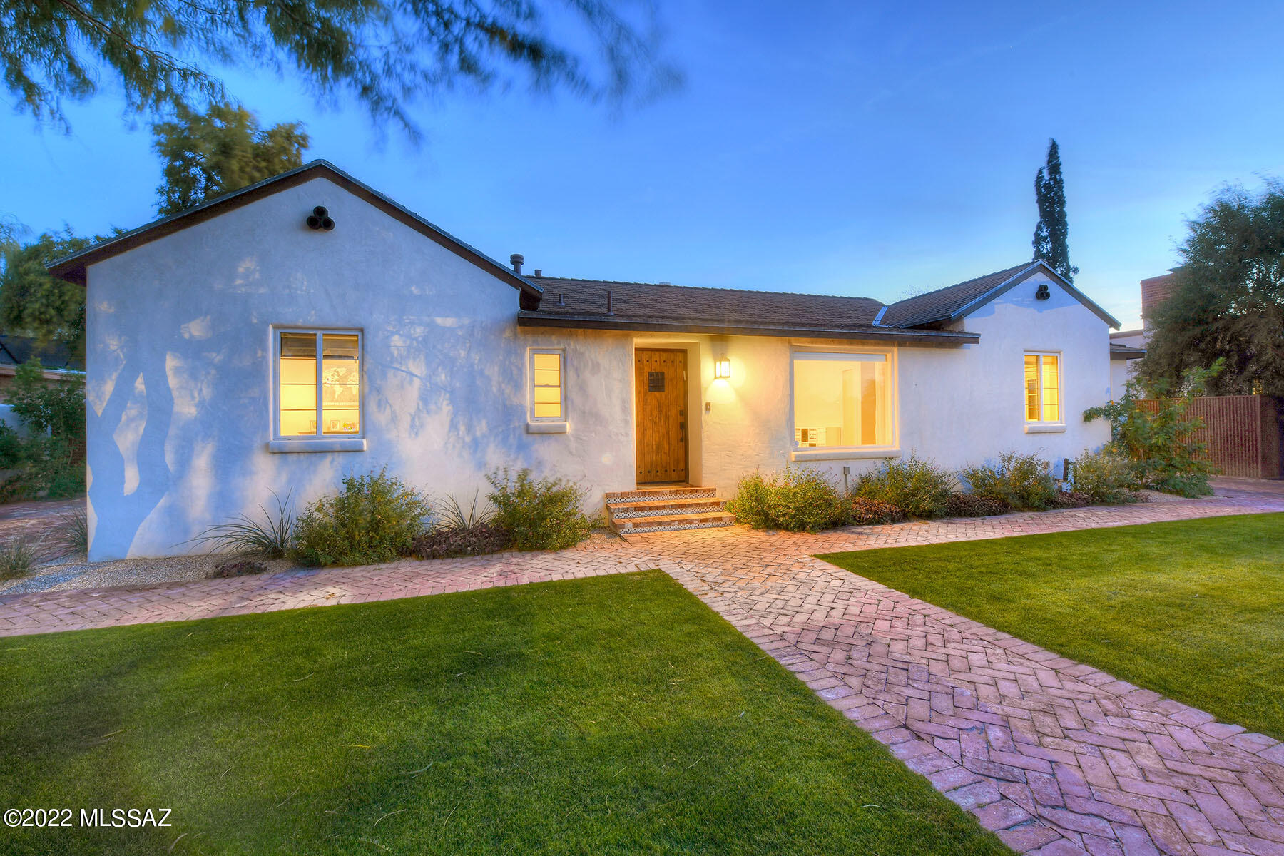 Sam Hughes 1936 Bungalow beautifully remodeled.  Blonde white oak floors & integral colored concrete floors.  Two way fireplace, formal dining room & Great room addition wlarge kitchen that offers a center-island with prep sink & breakfast bar, glass subway tile back splash, SS appliances which include two full double ovens w/10 burners, tons of storage plus a butlers pantry! Mud room w/half bath.  3 bedrms in the main house.  The primary bedrm has an ensuite bathrm, double sinks, private water closet plus huge walk-in closet.  Bedroom #1 has an ensuite bathrm.  Backyard has herringbone brick paver patio & custom ramada, grass & a separate guest studio w/kitchenette & ensuite full bathrm. Custom corrugated steel gates & fences. Tons of off street parking! Simply gorgeous home.