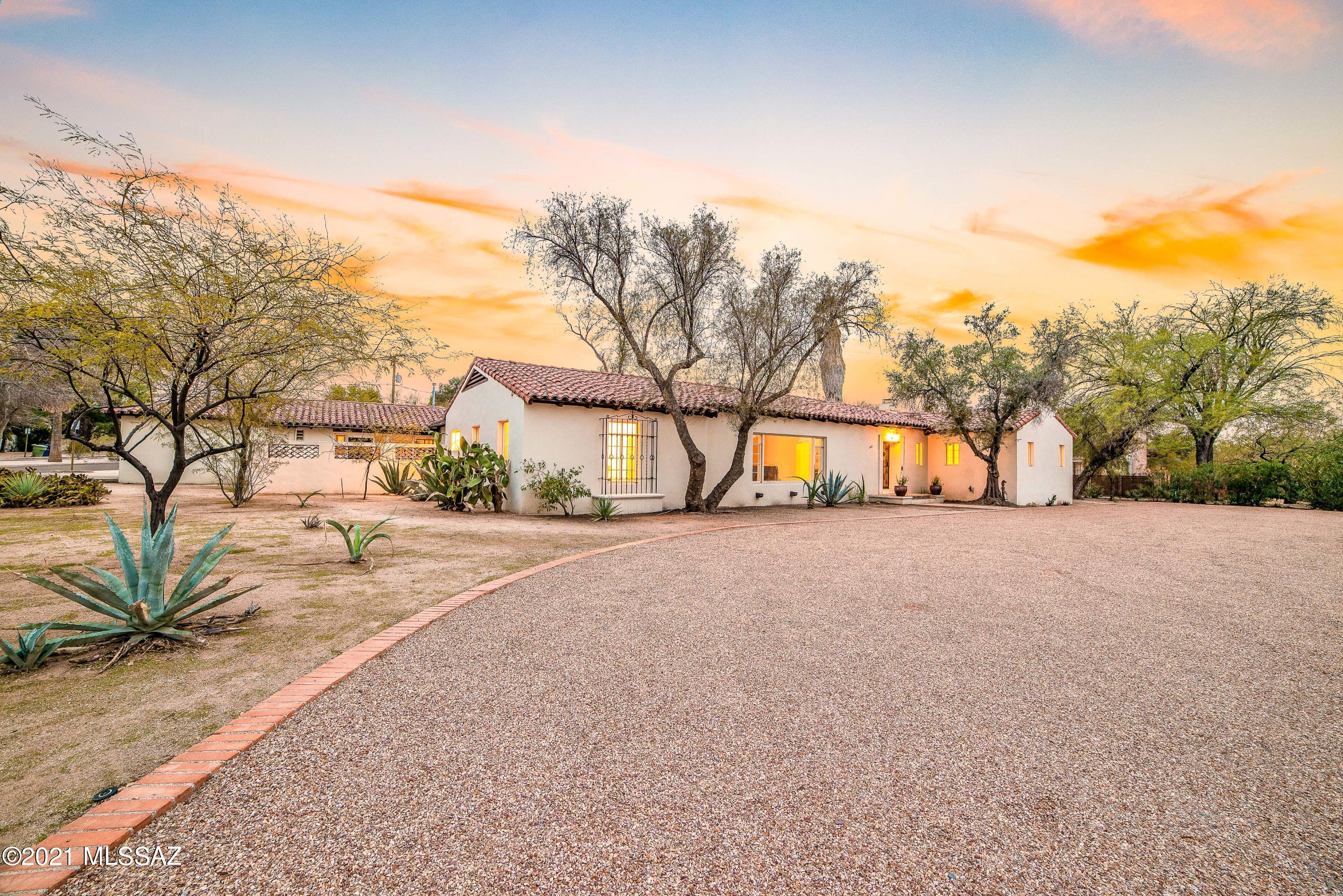 This extraordinary residence in Historic Catalina Vista embodies the charm & elegance of the Arizona Inn and Josias Joesler. Local architecture enthusiasts will be captivated as they step into a home where craftsmanship, quality, and style were not optional. The polished concrete floors of the formal living room with beamed ceilings opens to a large formal dining room. Through the vintage swinging door you will make your way to the original, exceptionally preserved, butler's kitchen which adjoins a gourmet kitchen with new stainless steel appliances, multiple ovens and dishwashers, marble countertops and luxurious cabinetry - truly an entertainers dream! In the west wing of the estate you will be captivated by the handmade doors with vintage hardware, coved ceilings, multiple fireplaces, bedroom with en-suite, library (or 3rd bedroom) and a gorgeous master suite with fireplace. The centerpiece of this majestic estate is the Arthur Brown designed ballroom featuring Terrazzo floors with brass inlay and 14 foot ceilings. Floor to ceiling windows frame a luxurious pool with new old-world pavers and custom wrought iron palisade. The south east wing of the home features a "maids quarter" and an attached 2 bedroom, 2 bathroom guest house with separate entrance. This jewel of Catalina Vista is truly a once-in-a-lifetime estate.