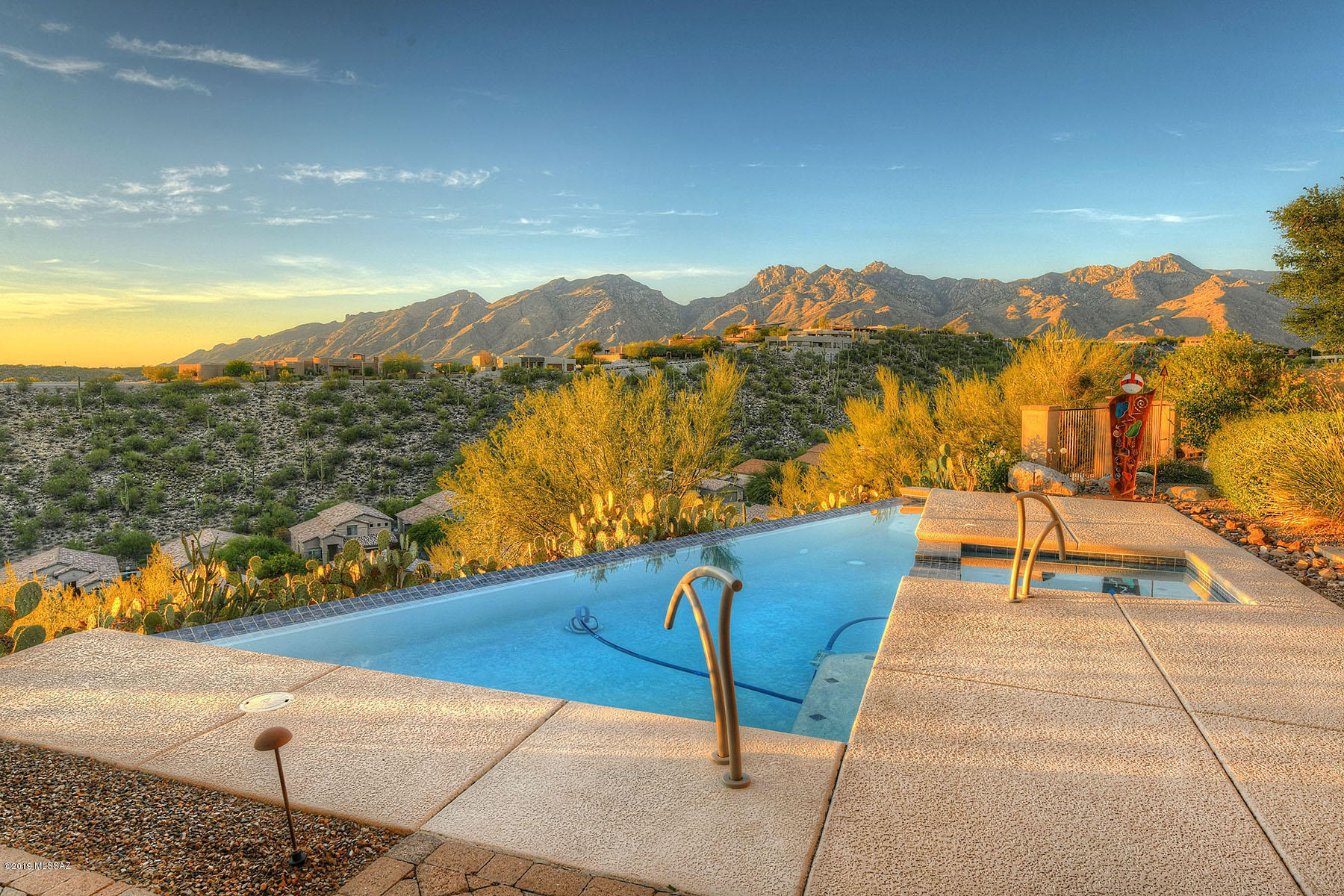 Impeccable taste & style await you. Custom one story home in luxurious gated Foothills Sabino Mountain community. Single story split plan 4 bed w/ 4.5 baths. 2 Master Suites! Breathtaking mountain, city & panoramic views. Premium finishes throughout. Foyer leads to living & dining areas w/ floor to ceiling windows taking advantage of every view. Kitchen has premium finishes w/ Clear Alder cabinetry, granite counters, double sinks, high end stainless appliances w/ 48'' refrigerator, cooktop, double ovens, dishwasher, warming drawer, prep sink, large island & built in desk area.  Open Family room off kitchen w/access to outdoor kitchen & backyard.All ANDERSON doors & MILGARD windows! Powder room w/ vessel sink & granite counters. Oversized Master Suite boasts large sitting area. Master has walls of windows, coffee bar & mini refrigerator, French doors lead to front & back patios. Master Bath w/ honed copper quartzite counters, double vanities, makeup counter, jacuzzi tub & large walk-in shower w/ multiple shower heads. XL California Closet walk-in.  All bed rms. are en-suite w/walk-in showers (oversized tubs in 2 of 4 baths). 1602 sq.ft  covered outdoor living space w/outdoor kitchen, gas BBQ, refrigerator & bar seating. Negative edge pool w/ spa & paver patio. Large seating area w/tempered glass fire pit & pond w/ dual fountains, lush landscaping + Orange, Grapefruit, Lemon & Lime trees. Laundry room w/ washer/dryer & room for refrigerator, granite counters, wash sink & hanging bar. Additional amenities include:  Solid alder wood doors, skylights high end hardware, lighting & fixtures, 20" tile Porcelain tile in all living spaces, upgraded carpeting in bedrooms, niches throughout, coat closet, alarm system, Bose system inside & out and 4 fireplaces. 1077 sq.ft. 3 car garage w/storage, new epoxy flooring, water softener & large storage room w/ utility sink. Generous built-in storage thru-out home. Rare find!!