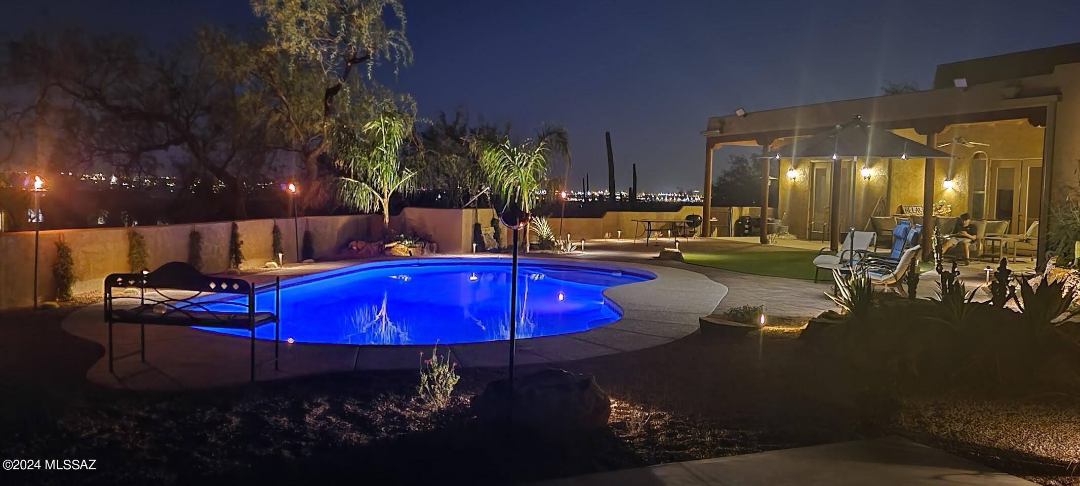 Experience Tucson living in this Territorial family home, tucked in a gated community bordering Coronado National Forest. Enjoy panoramic views from the doorstep. Inside, the split floor plan ensures privacy, accentuated by soaring ceilings. Entertain in the grand Living Room with vigas and a fireplace or in the Family Room connected to the gourmet kitchen equipped with WIFI double ovens, touchless microwave, island, breakfast bar, breakfast nook, and pantry. Retreat to the Master Bedroom suite boasting dual closets, double vanity sinks, a jetted tub, a two-head shower, and a second Master suite offering versatility. Step into the renovated backyard oasis. With prime location near schools and mountain vistas, this sanctuary offers luxury and tranquility. Don't miss out, schedule today!
