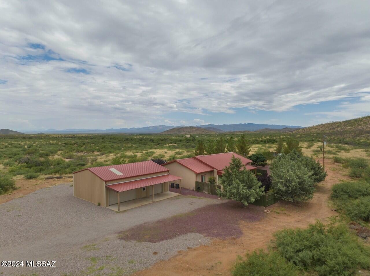 Here's your opportunity to own a custom home on 36+ acres, zoned RU4, and backs up to State Trust land. The road is paved driving up to the property and the lot is completely fenced. This home features hickory and cherry wood flooring, 9' ceilings, elegant bathrooms with double vanities, a new water heater, and 2 new A/C units with 10yr warranties! The kitchen is thoughtfully designed with alder wood cabinetry, cherry wood countertops, and newer appliances. Using only the finest materials, the house was constructed with steel studs, a metal roof, and built on a raised 3' raised block stem-wall giving the home a ''soft floor'' and easy access to the plumbing. The back porch was recently rebuilt and is perfect for enjoying your outdoor kitchen and garden. Schedule a tour of this home today!