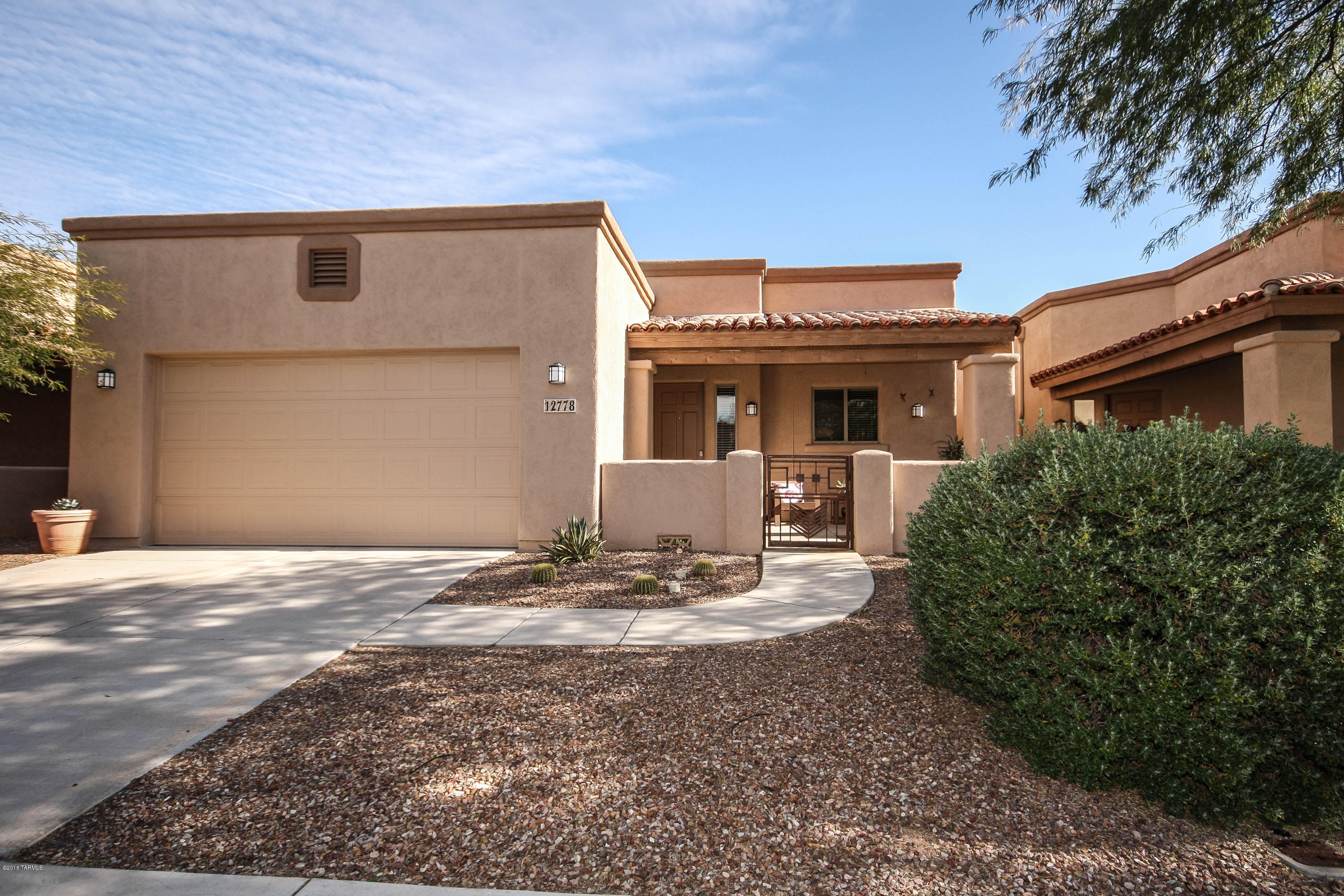 You'll love this beautiful 3 bedroom 2 bath charmer!  Split floor plan with open kitchen to the living areas in this house.  Saltillo title throughout gives this home a warm but contemporary look.  This home overlooks a landscaped low maintenance back yard larger than most in this neighborhood.  Front and back patios with ceiling fans in both.  Large master suite with a walk in closet.  This gated community is within walking distance to a grocery store, and restaurants ans shops.  Leased Solar Panels will ensure  very low utility bills .  Great energy saver!  Special Financing Incentives available on this property from SIRVA Mortgage.