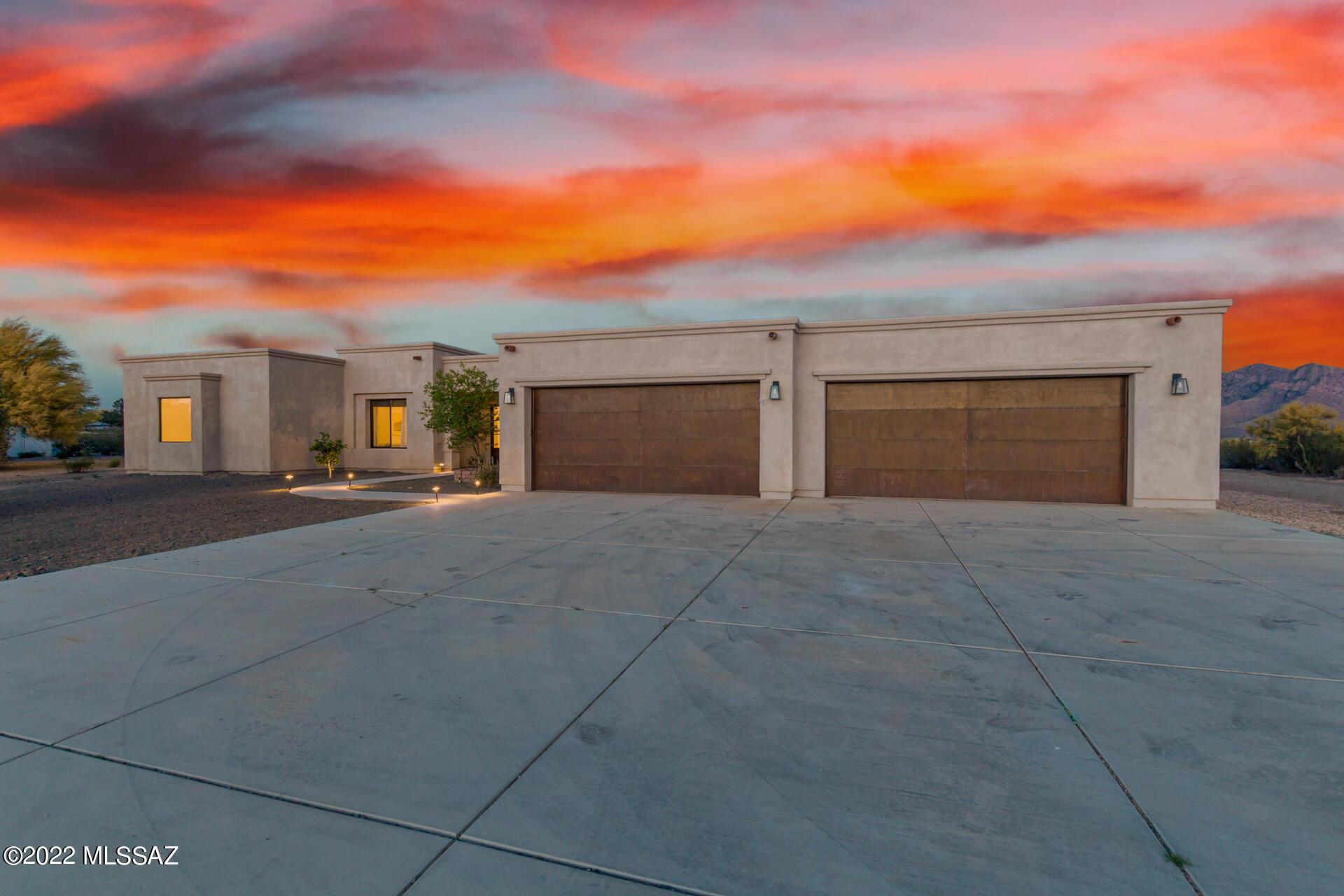 One of a kind property in Oro Valley. This property has 4.77 acres with 3563 sq ft, 4 bedroom custom home built in 2017 with a 1292 sq ft guest house that includes 4 bedrooms, great room, new ac, new paint and new flooring (would make a great rental or in-law home). Property includes owned solar, owned well with a 3000 gallon holding tank. Fabulous mountain views, kitchen has marble counters, large island, Sub-Zero Fridge, 48'' Dacor Range with 2 ovens, 4 gas fireplaces, tankless water heaters, two sets of washer and dryers (1 in master closet). Covered patio has pavers, smoker, large built-in BBQ and double gas fireplaces. Perfect location, close to schools, shopping and no HOA!
