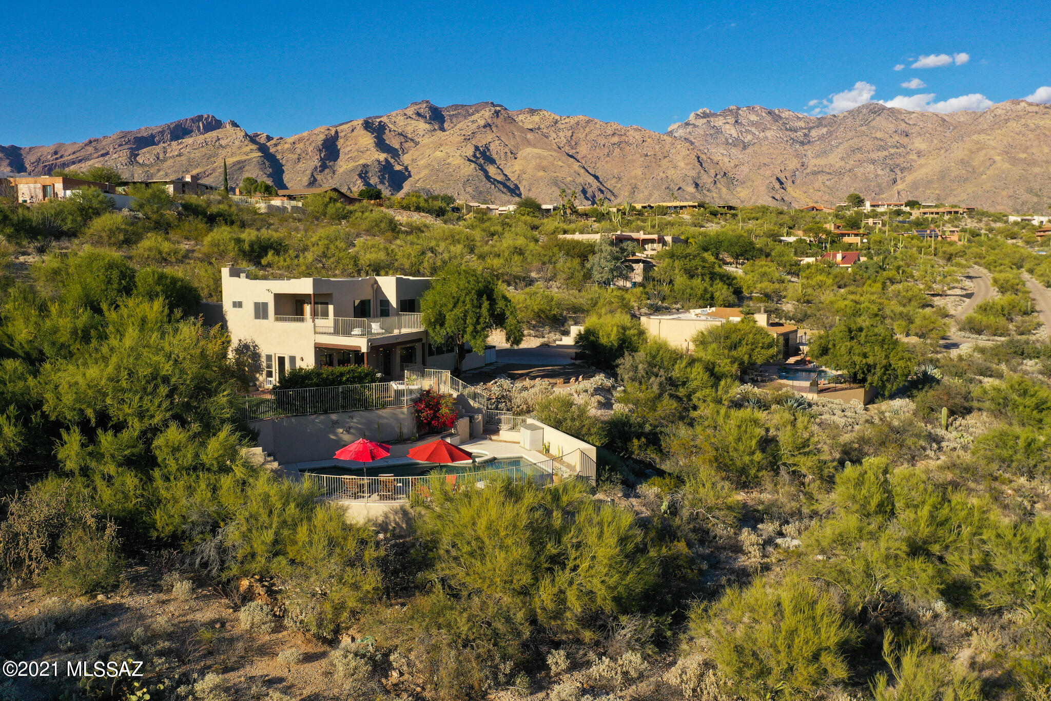 Incredible split-level home on over an acre nestled in the Cimarron Foothills Estates with privacy and views!
This recently remodeled home features a spacious and bright gourmet kitchen with a large granite island, all stainless appliances, including a gas cooktop, the all tile floor on the first level leads to an open great room, perfect for entertaining or just kicking the shoes off after a long
day. A formal living room welcomes guests on the mid level with all bedrooms located on the top
level featuring wood floors.  The remodeled owner's suite has a modern spa like feel with a separate step in shower and a free standing tub.
The walk-in closet is a good size and features built-in organizers.... more on next page... Step out to the
back yard and you will be greeted by a covered patio, extended pavers, a new low maintenance synthetic turf area with fruit trees and down steps to a heated/salt water pool and spa with beautiful views!
Schedule a showing and see what the Tucson Foothills lifestyle looks like.