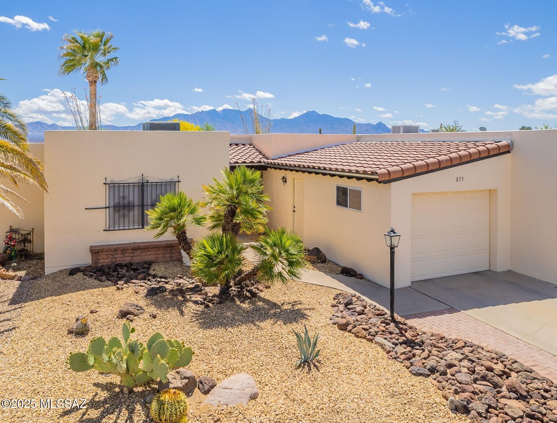 Panoramic mountain views greet you from the entry, living room, primary BR, and back patio of this very popular model townhome in this very sought-after subdivision!  It also has a very private desert setting to enjoy the birds and wildlife sanctuary.  It has 2 large Bedrooms and 2 Baths.  Kitchen and entry way are tiled, and it has a nice breakfast nook area with pantry.  Dining area has built-ins for a desk and china cabinet affect--lots of storage!  Included is a 1 car garage, and additional parking for guests nearby.  Located in the heart of Green Valley and within walking distance to pool, spa, rec. center, and Continental Shopping Center.  To get you started, it is also furnished, per inventory.  Did I mention the mountain views--outstanding!  It's priced to sell!  Don't miss out!