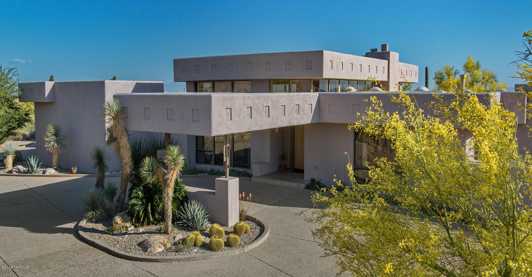 A spectacular desert contemporary home designed by Tyson, tucked in on a private cul de sac within gated La Paloma Estates. Exquisite 14' wood ceilings with an abundance of windows that take advantage of the natural light and stunning city and mountain views. This meticulously maintained 4700 sf, 5 bedroom (including separate entry guest qtrs), 5 bath home offers a porte-cochere entry, a fabulous chef's kitchen with an expansive center island, a gracious master suite featuring one of 3 fireplaces with an ample walk in closet, and large master bath with a steam shower, Jacuzzi tub and exercise area. Multiple outdoor spaces surround the pool and spa, a protected vegetable garden and wonderfully landscaped areas to enjoy the evenings. Designed by one of the city's ''notable architects''