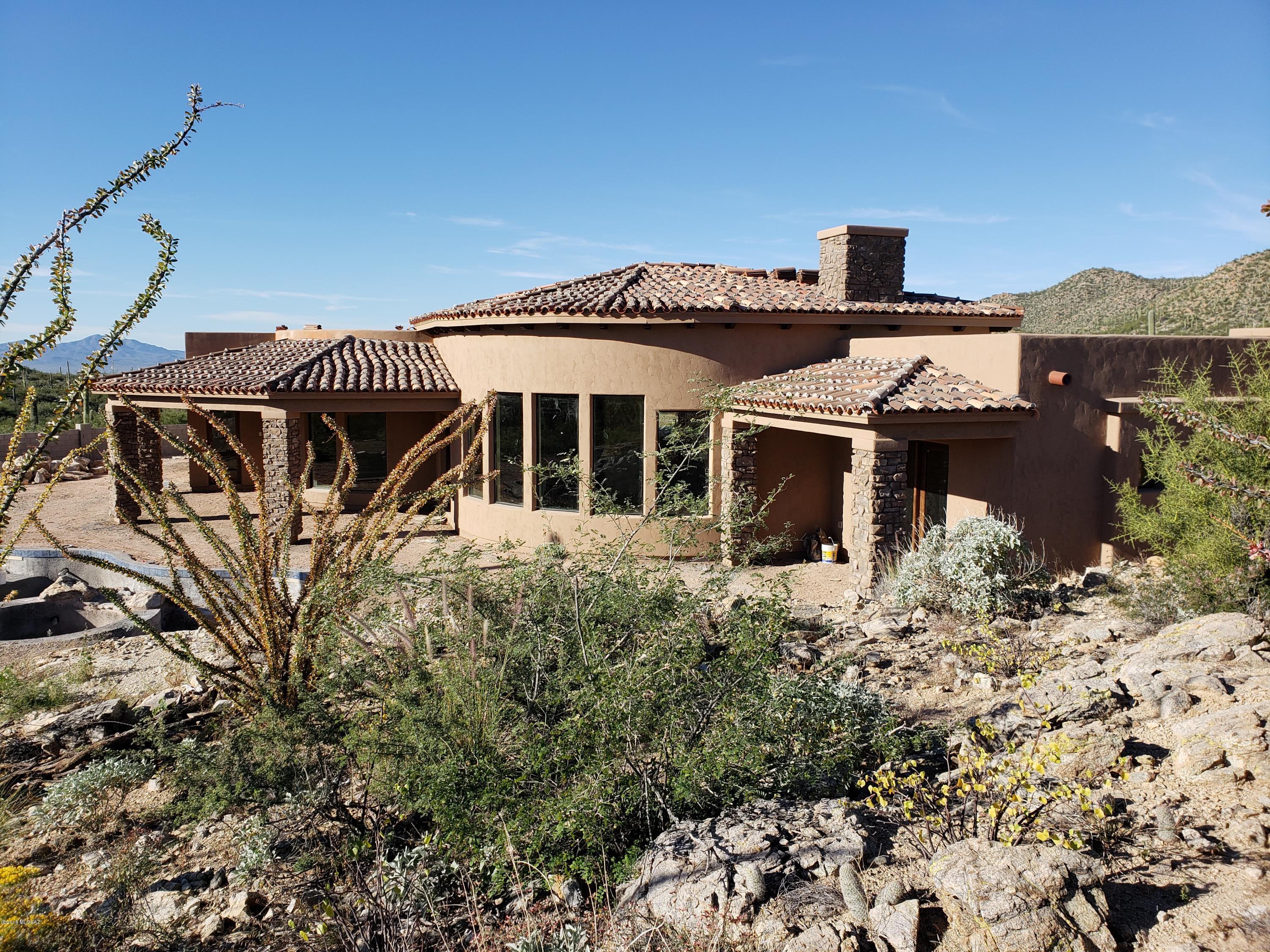 Old World Tuscany inspired home in the exclusive 41 parcel Tuscan Estates subdivision of Stone Canyon. Breathtaking Catalina and Tortolita Mtn views, Great room with its soaring ceiling, wall of windows, large island kitchen, professional appliance package, with adjacent Nook and Great room, opening to large covered patio BBQ area. 8'' knotty alder doors throughout the 4158 square foot residence of four bedrooms with baths, a study, plus a Master with a soaking tub, large walk-in shower, oversized walk-in closet and a private rear covered patio. Travertine floors throughout. Large three car garage, and a covered front entrance patio. Community pool/spa, tennis, exercise facility, clubhouse, and restaurant plus the award winning Stone Canyon golf course w/optional membership.