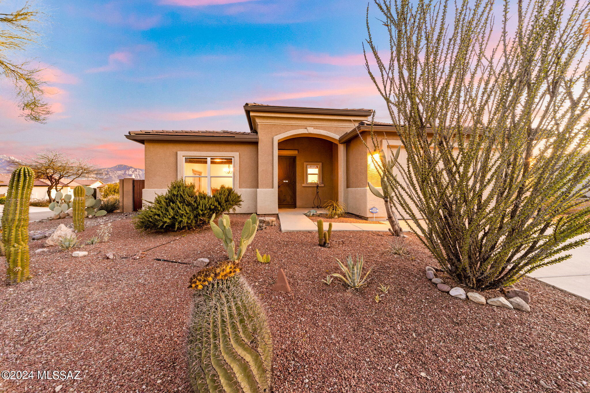 Nestled in the serene landscape of NW Tucson, discover the epitome of Southwestern charm.  With 2082 sq ft the interior  exudes warmth and character. A well-designed, open floor plan connects living spaces, creating an inviting atmosphere for both relaxation and entertaining. With 4 bd & 2 ba, luxurious travertine flooring in living areas, carpeted bedrooms, spacious laundry room & garage storage racks. The chef's kitchen is a culinary haven, featuring granite counterts, SS appliances, ample cabinetry, & center island, perfect for hosting friends and family. Step outside to discover your own private sanctuary amidst the desert terrain.The expansive covered patio provides the ideal setting for alfresco dining, soaking in the heated, saltwater pool and enjoying the breathtaking Mtn sunsets. This inviting property offers a harmonious blend of elegance and modern comfort, creating an idyllic retreat for those seeking a tranquil lifestyle.A Peaceful Retreat, whether you're seeking a full-time residence or a vacation getaway, this Southwestern oasis offers the perfect blend of tranquility, luxury, and convenience, making it an exceptional opportunity to embrace the Arizona lifestyle