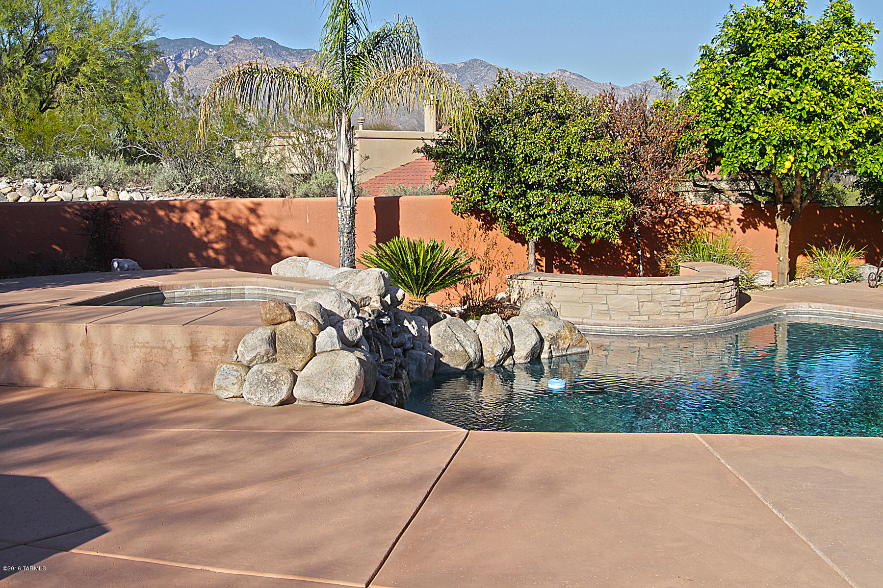 Stunning custom contemporary with loads of SW charm located on primo private lot in popular gated foothills community. Open & inviting living space w/fabulous kitchen, grand great room and big area dining make the perfect place to entertain. A kitchen any cook will enjoy offers lots of custom features, loads of storage, counter & cabinet space. AZ outdoor living at its best features Catalina mtn views, sparkling poo, spa & waterfall, extensive covered patio & built-in bbq. Luxurious master retreat offer huge bath,walk-in shower, his & hers closets. Split floor plan with 2 generous guest bedrooms.  4th BR has built-ins that make this a great home office. Huge laundry room, oversized 3 car garage, beautiful brick paver driveway and lovely courtyard entry.