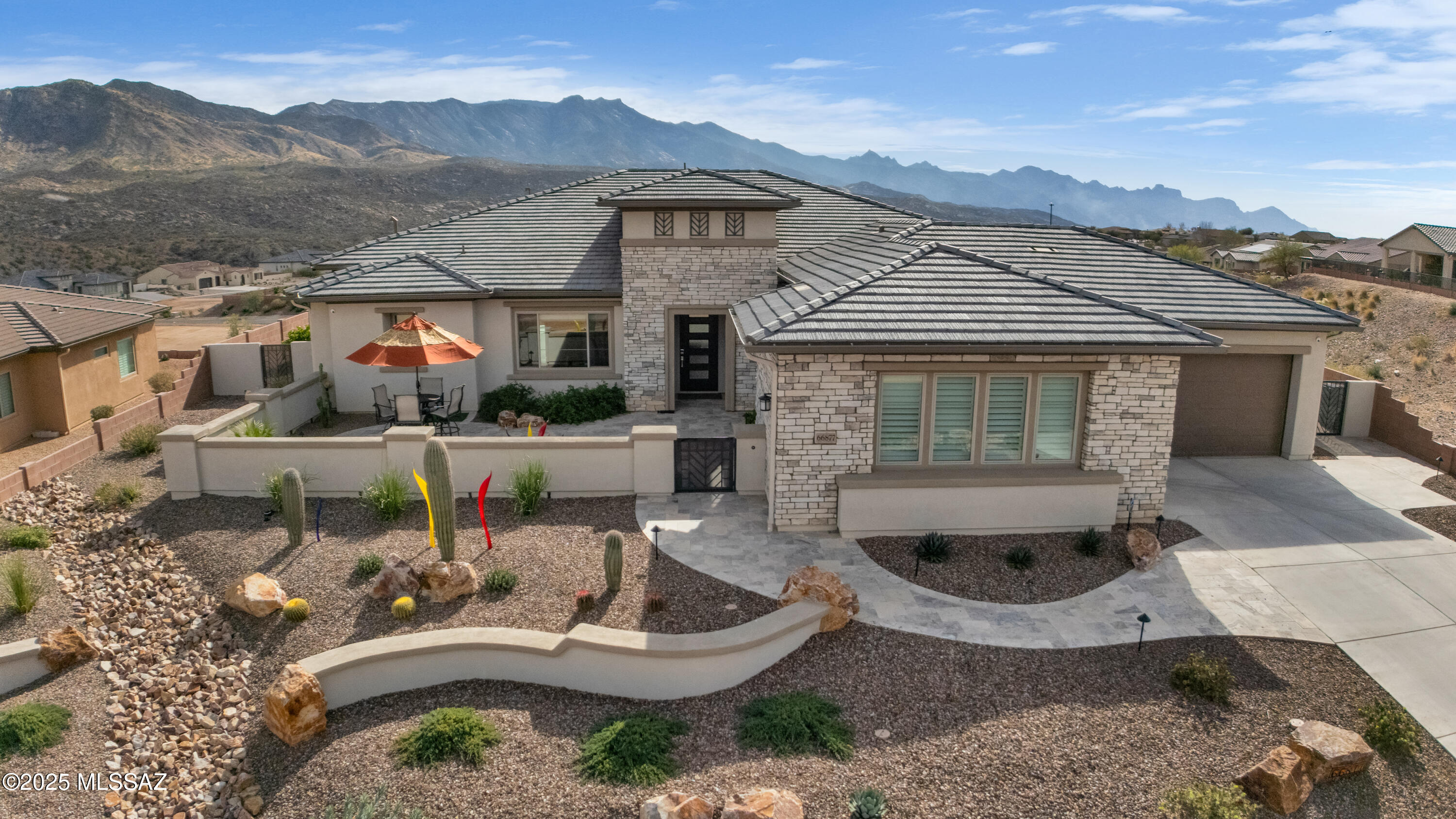 Contemporary 'Tech Savvy Home' built in 2022 offers sleek sophistication. Quiet location in The Preserve at SaddleBrooke at the top of the hill featuring sweeping views of the Catalina Mt Range. This upgraded Sonrisa plan features luxury appointments providing beauty and function. Porcelain tile floors grace every room with remote controlled Hunter Douglas Custom Window Treatments and Haiku fans and lights. Zoned audio with ceiling speakers in 6 rooms plus a security system with Indoor/Outdoor cameras. True Gourmet Kitchen features Sub-Zero 36'' Refrigerator/Freezer Towers, upgraded Wolf appliances, upgraded cabinets with custom hardware and Cambria luxury series countertops and Oversize waterfall island. Owned solar (Enphase 28 panels) installed 3/2024- and 50-amp EV charger. This Tech Savvy Home has the following systems Wi-Fi programmable, and App controlled by your Mobile devices: 

Haiku "Big Ass" Ceiling Fans & Lutron lights, Hunter Douglas shades, Lutron Art Lights, Rolling Electric Patio Screens / Shutter, HVAC Zoned temp control, Sub-Zero/Wolf appliances, Rainbird landscape irrigation controller, LG Laundry control, myQ garage door and 7 security cameras and SimpliSafe home security system and Enphase Solar Panels, Capable of Producing: 11.900 Kw DC, 9.100 Kw AC . 

Additional features: 

Closets / Pantry:  Custom "Closet Trends" Systems in His / Her walk-in Closets and Kitchen Pantry. 
Kitchen: Cambria Luxury Series Quartz countertops, contemporary backsplash and waterfall island. Upgraded "Maverick Style" cabinets with 5-piece door fronts & Shaker crown molding throughout. Lighting above & under cabinets. Decorator hardware and accessories. Kitchen roll-out shelves. Upgraded appliances: Wolf Convection/Steam oven, Wolf M-Series Gourmet oven, Wolf 36-inch gas cooktop with Infrared Griddle & stainless hood vent. Pot filler faucet. Cove dishwasher. Subzero 36/36 Refrigerator / Freezer towers. Separate Butler's pantry with Sub-Zero Icemaker. 
Reverse Osmosis Tap at Kitchen sink, that also feeds Sub-Zero Freezer Ice Maker & Sub-Zero Pantry Icemaker. 
Dining Room:  Eurofase Contemporary dining room LED Chandelier and ( 3 ) Kuzco LED Island Pendant lighting. 
Whole House: Two Tone interior paint of interior walls & trim. 5 1/2-inch baseboard trim.  
Bathrooms: Upgraded showers with Porcelain tile extended to ceiling.  
Granite counters in baths and laundry room. 
Garage: Epoxy coated floor. 12-piece garage cabinet system, overhead storage Shelving, wall mounted tool storage organizer. Rinnai Tankless water heater with Hot Water Recirculation pump. 
Landscape Design:  Includes Front enclosed courtyard with travertine stone patio. Fully fenced yard, artificial turf, travertine back patio and walkways & raised garden. 
Whole house gutter system drained underground to street 
Solar Roller ( 2 ) Screens with ( 1 ) Rolling Shutter ( West Side ) completely enclose the patio when lowered. 
"SoftPro" Whole House Water Filtration and Water Softener System, with UV Light.  
Upgraded Electrical / Home Technology / Media Room Options. 
4 flat screen TVs convey.
Audio/video equipment may be purchased separately.
Some furnishing may be available on a separate BOS.