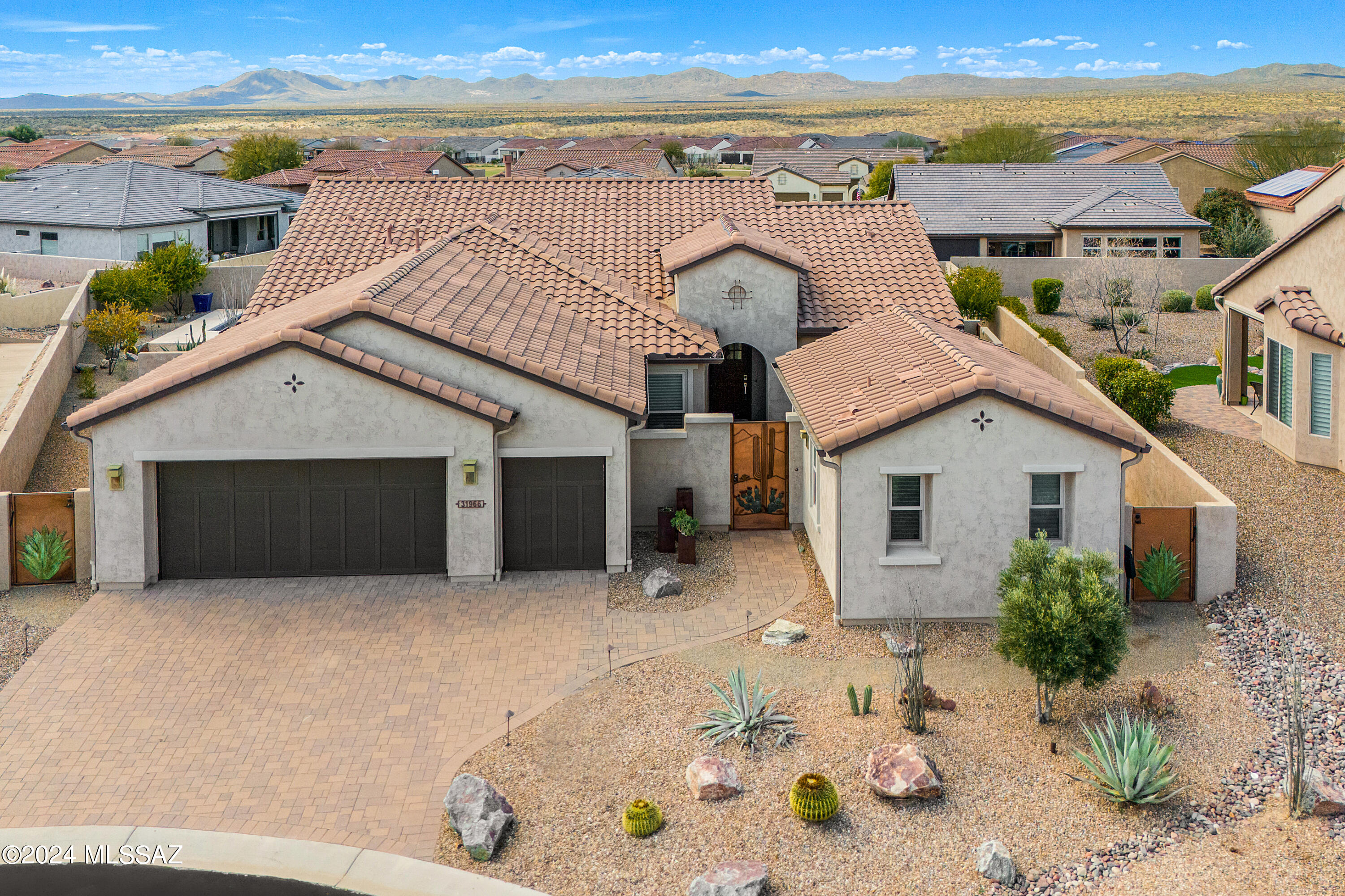 Welcome to this stunning, modern oasis nestled in the heart of a guard-gated, secluded neighborhood! Built in 2016, this meticulously updated residence spans 2,357 sqft of pure luxury. The main house boasts 2 bedrooms and 2.5 baths with a spacious 1 bedroom/1 bathroom casita, featuring a beautiful split floor plan for ultimate privacy. Step into elegance as you enter the spacious front courtyard, complete with a cozy fireplace, perfect for entertaining or simply unwinding. Inside, you'll find a formal dining room and a separate den with built-ins, offering ample space for relaxation and productivity. The kitchen shines with custom lighting and extra cabinetry, complemented by sleek modern appliances. Enjoy the convenience of a fully owned solar panel system, ensuring energy efficiency year-round. Retreat to the master suite, featuring a lavish en-suite bath and a walk-in closet. Guests will love the private casita, complete with its own bedroom, bath, mini-fridge, and walk-in closet. Outside, discover paradise in your private backyard oasis, featuring a 75-foot lap pool surrounded by travertine hardscape. Fire up the built-in BBQ for al fresco dining, or simply bask in the tranquility of your lush surroundings. Indulge in the amenities of the active adult community, including a restaurant clubhouse, tennis courts, pickleball courts, and a dog park. With a golf course just steps away, every day feels like a vacation. This cul-de-sac lot offers the utmost privacy, with a paver driveway leading to your 3-car garage. Don't miss this opportunity to live in luxury in one of the most coveted communities. Schedule your showing today and make this dream home yours!