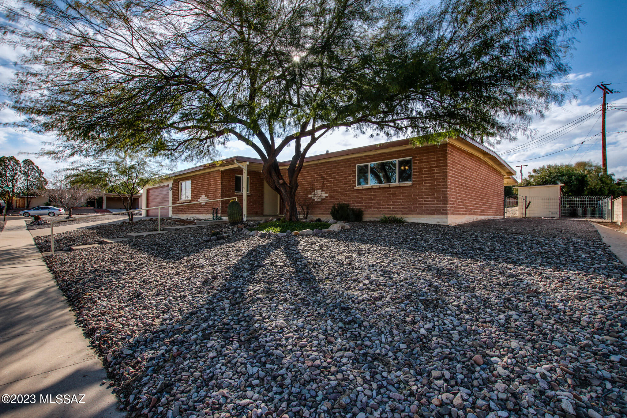 Great East side location! Resting on a large corner lot you will find this Wonderfully updated 4 bedroom, 2 bath home.  Open and bright floor plan features a beautiful kitchen with granite counter tops,  custom backsplash, SS appliances and gas range.  Spacious Great Room boasts a cozy fireplace for those chilly Arizona nights.  The backyard includes an extended covered patio, flagstone, storage shed and double gate for additional parking. Come take a view and make this your home today!
