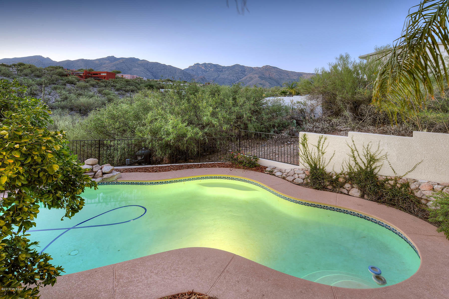 Cimarron sweetheart! Beautifully updated 1970's, 1659 sq foot Contemporary home on .97 acre lot with an incredible view from your north facing patio, pool &  covered patio. Living room with a fireplace. Dining room, upgraded kitchen with newer SS appliances, granite counter tops & plumbing fixtures, breakfast bar and eat in area with great views of the Mt's.  3 bedrooms 2 updated bathrooms which includes the master en-suite bathroom.  Newer dual pane windows throughout. Freshly painted inside and out! Patios, pool, covered bar area! Borders a green belt very private!  Plus a two car garage, large storage area and tons of off street parking!