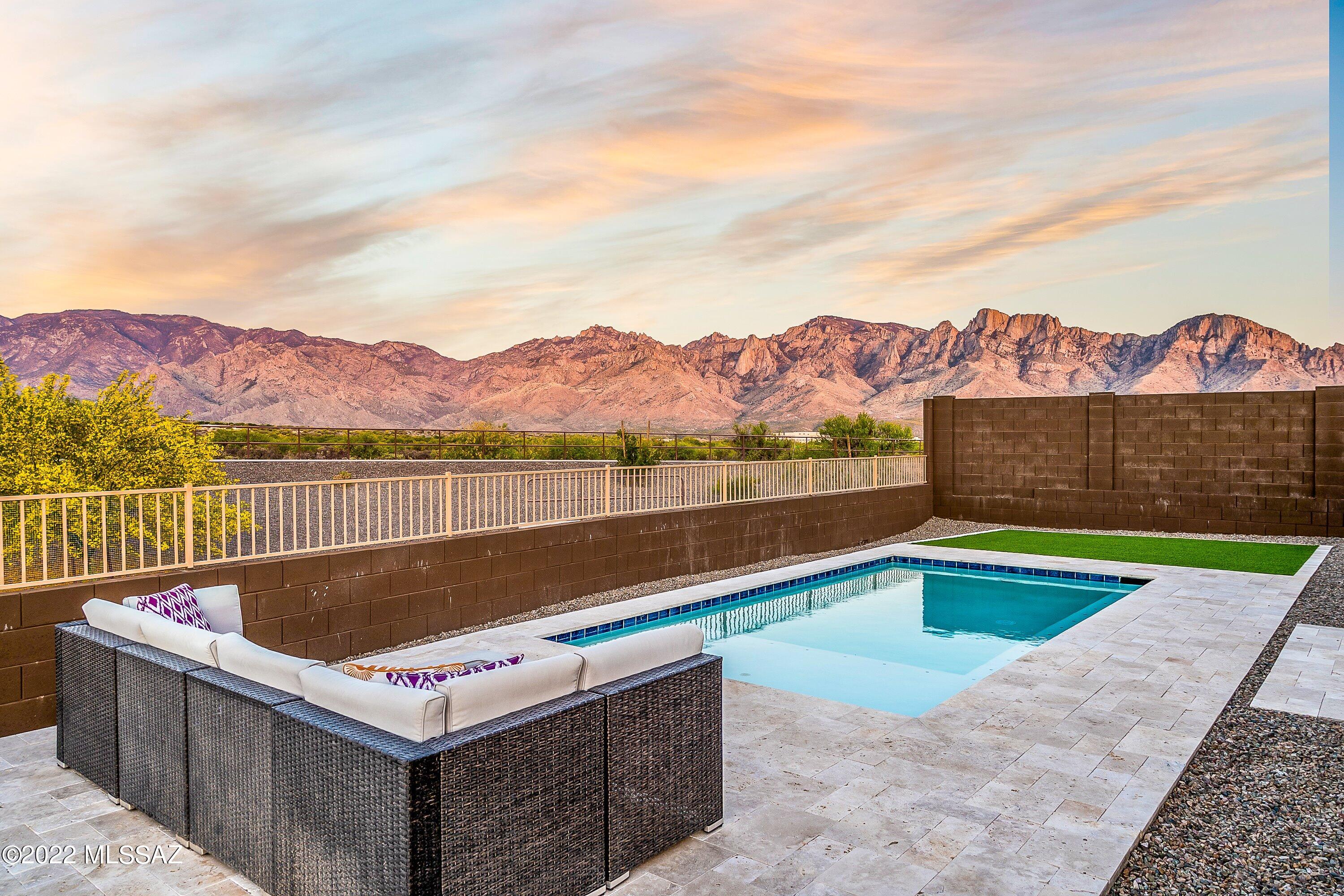 Want the beauty of UNOBSTRUCTED CATALINA VIEWS & an oversized lot?  Welcome home!  Can't find a nearly new home with pool already complete?  It's right here!  4BR 2.5BA + den w/ builder warranty!  Super popular Ravenna model.  Spacious kitchen with quartz counters & granite waterfall island, SS appliances featuring 36'' gas cooktop, oven, micro, & fridge. Huge primary suite with stunning shower, double vanity, and walk-in closet. Laundry boasts cabinetry & beautiful butcher block counter. Nest thermostats & smart switches included.  Valley Vista has an amazing multi-use path w/ STUNNING VIEWS; dog park and playground nearby.  Lot backs up to open space & wash for added privacy. 1.3 miles to Tucson Loop Path.