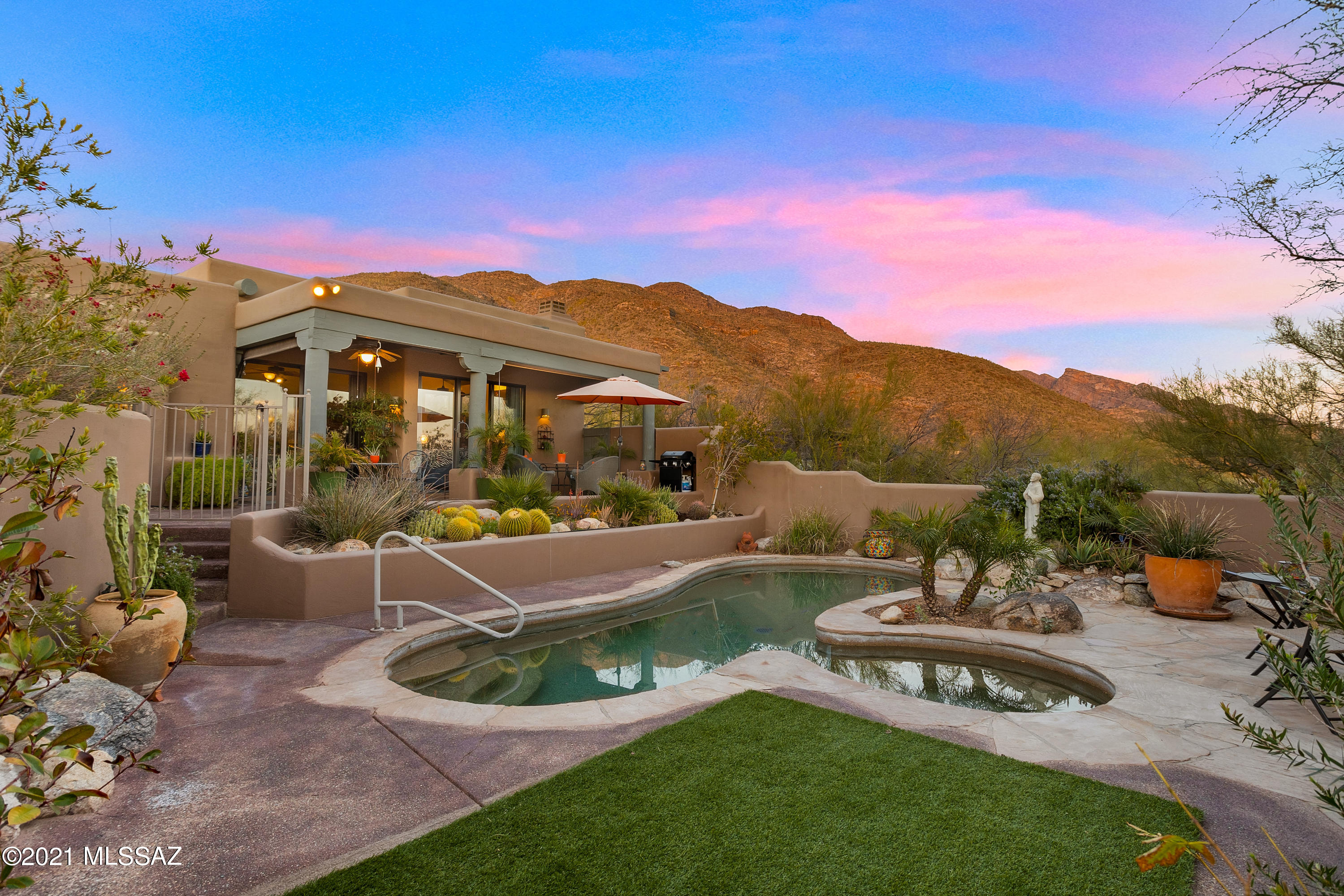 Gorgeous mountain views from this southwest style home situated on private  cul-de-sac lot in the Guard Gate Community of  Sin Vacas.  Fireplace seperates formal living and spacious dining room with cherry wood flooring. Kitchen has stainless appliances, quartz counters, island and opens to family room featuring vega beams &  additional fireplace. Split bedroom layout offers ensuite guest room. Den has built-ins but can double as a 4th bedroom. Lush landscaped backyard with pool, spa and sparkling city lights. Large 3 car garage with extra storage.