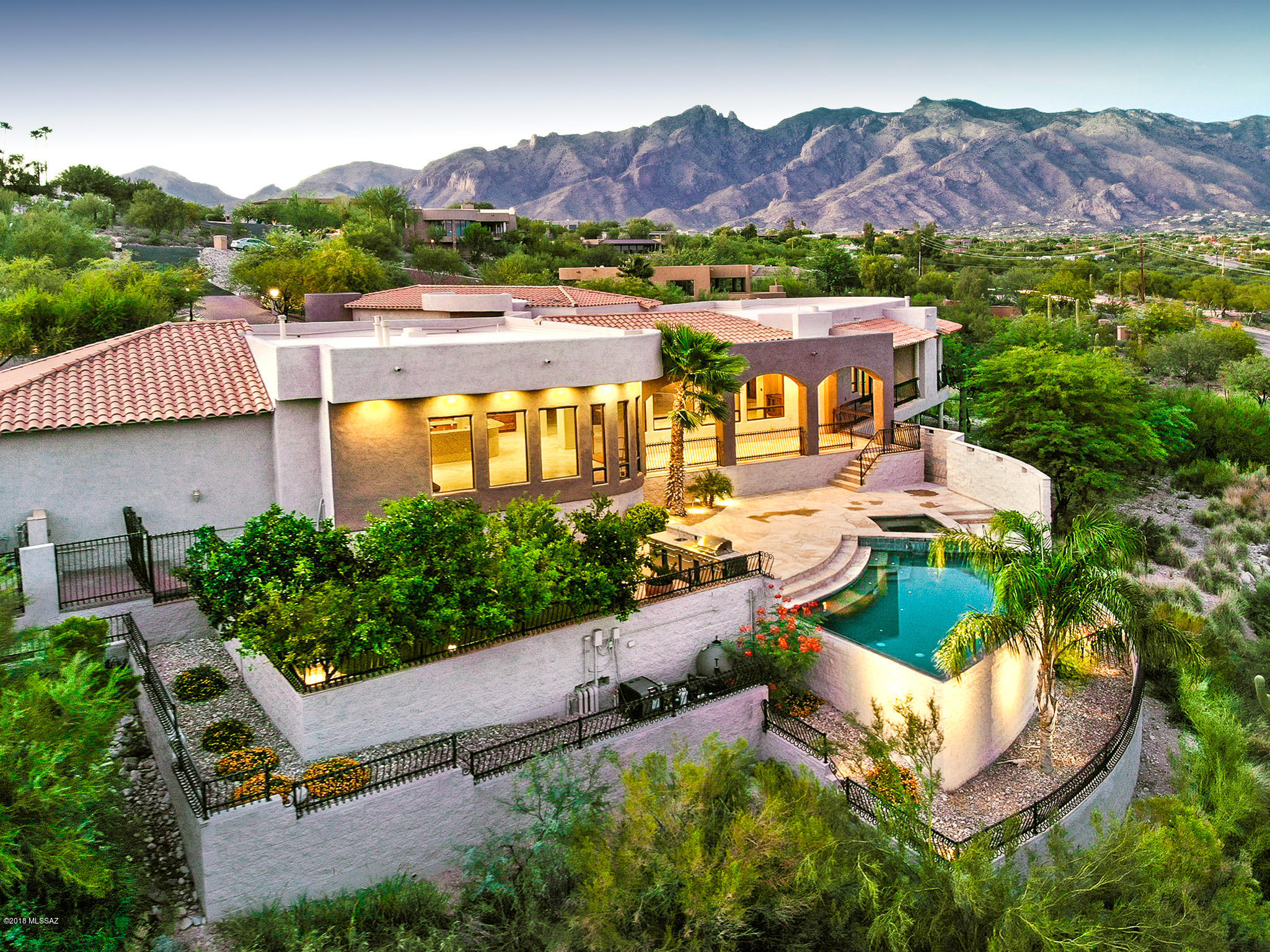 Nestled in heart of the Tucson Foothills, awaits this stunning 7,855 square foot  plus home in the prestigious gated community of Eleven Arches. This superbly constructed estate is built on a scale to offer both intimacy and expansive entertaining. Majestic mountain and city views from every room. Interior features include 6 bedrooms, 6 baths, grand kitchen with 2 ovens, 2 dishwashers, wine cooler and a perfectly hidden butlers pantry. Lifestyle features such as media room, game room, exercise room, elevator, add to the stunning individuality of this home. Additional features include beautiful outdoor negative edge pool and spa, outdoor BBQ, and an indoor swimmers exercise pool. Wrap around balconies, security cameras throughout the property and a private driveway. There are many more details so feel free to contact me for a full list of recent updates and upgrades.  Welcome home!