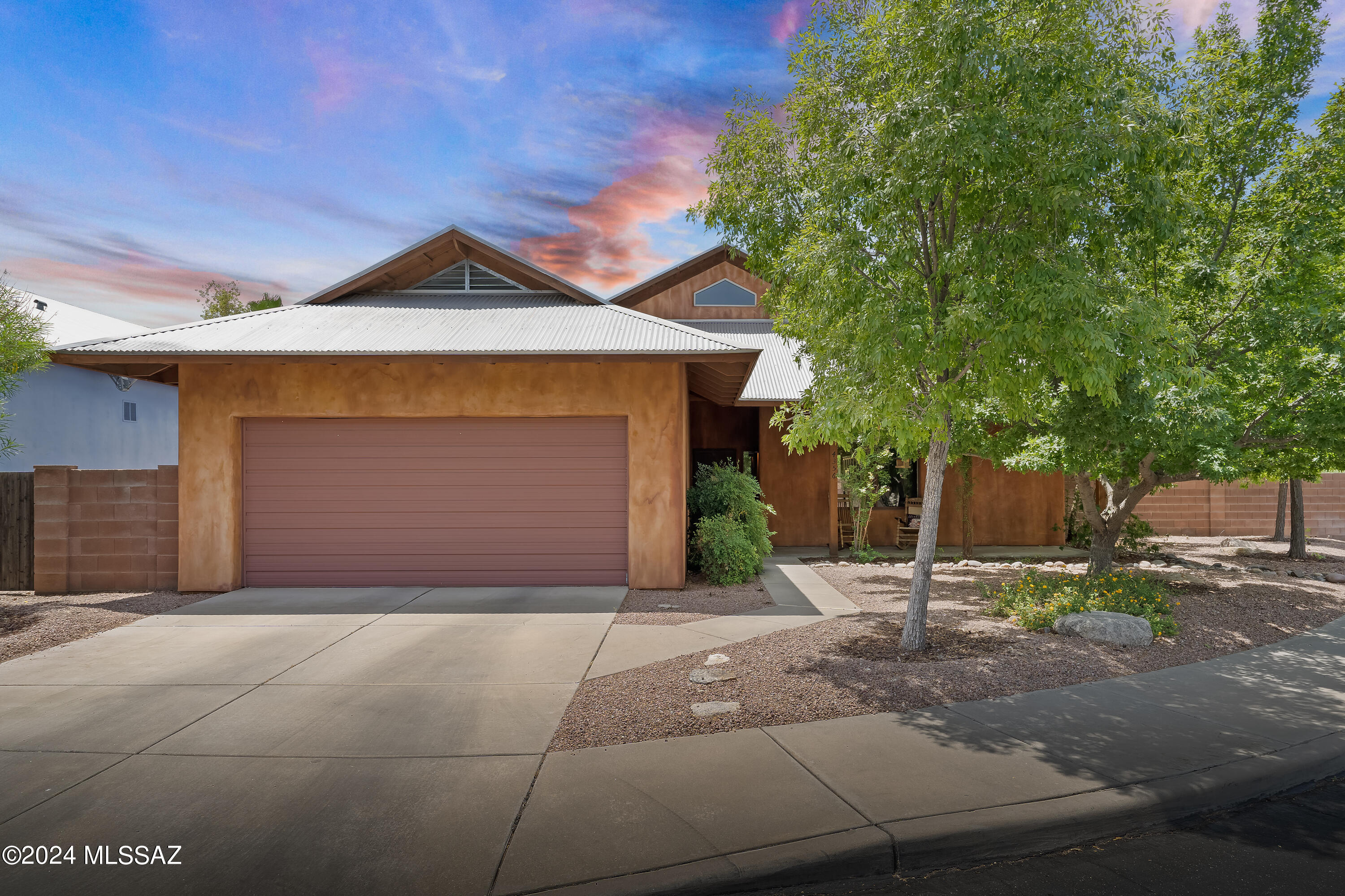 Homes rarely come on the market in the gated enclave of North Mountain Park. Thoughtfully designed by award-winning architect, Ron Robinette, this special home offers the perfect blend of privacy & proximity. Located on a quiet cul-de-sac, this home features an open concept floor plan with 2 primary bedrooms each with generous sized walk in closets, full baths with a soaking tub and sep shower, inviting kitchen with stainless steel appliances, island & bar seating and plenty of storage...concrete floors, high ceilings, & exposed beams create a spacious and airy atmosphere. Versatile loft space makes a great office, den/ media room or exercise area. The backyard is highlighted by a generous covered patio, firepit, & mature trees. Incredibly low maintenance metal roof and garage has AC! This ideal location is adjacent to Loop access, and about a 10 minute drive to the U of A, a few minutes to Trader Joes, and St. Philip's Plaza (farmer's markets on the weekend)! A couple more items...this home has stairs that go only to the loft space, both bedrooms are on the main floor. Floor plan available. There is a family of owls that likes to hang out on the backyard porch at certain times during the year. There were 5 last year, and now there are 6!