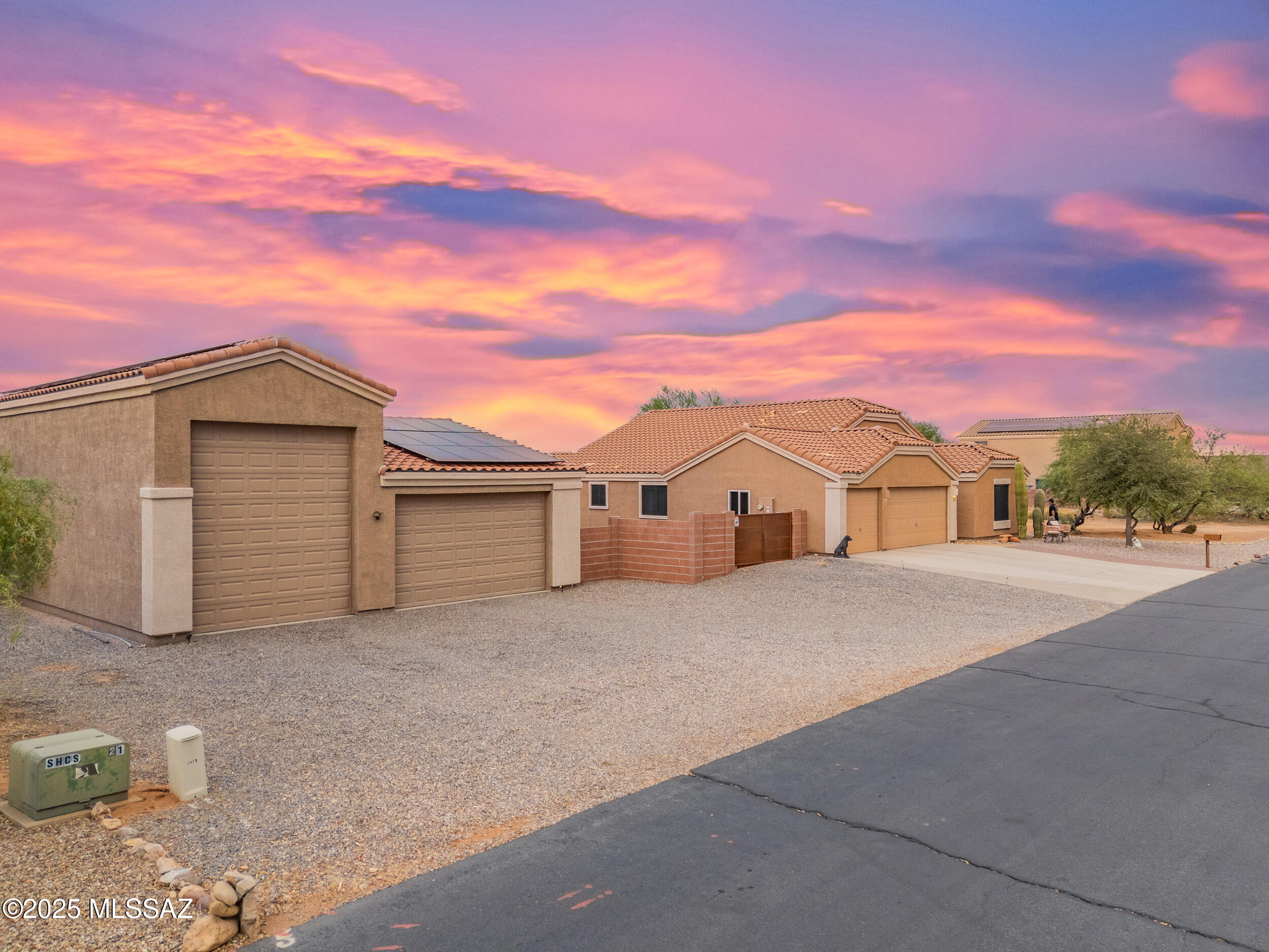 Stop scrolling. This home is THE ONE. 
Nestled on a sprawling 1.5-acre lot with breathtaking panoramic mountain views, this one-of-a-kind property is a true desert oasis, blending luxury, functionality, and entertainment. The estate features a beautifully updated 3-bedroom, 2-bathroom main house, a detached 2-bedroom, 1-bathroom guest house, a massive RV garage, and a heated in-ground pool, creating the ultimate retreat for discerning homeowners. Step into the main house and be greeted by soaring vaulted ceilings that create a grand, airy entrance. Luxury vinyl plank flooring flows through the main living areas, exuding warmth and sophistication. The chef-inspired kitchen is a masterpiece that features ample counter space, granite counter tops, and an inviting spacious island. This thoughtfully designed split-bedroom floor plan offers two additional bedrooms down the hall, each with spacious walk-in closets. The primary bedroom features a beautifully remodeled spa-like bathroom complete with your own soaker tub, spacious shower and dual walk-in closets for him and her. Step outside and discover your own desert oasisan entertainer's dream come true. The sparkling pebble-sheen pool provides a refreshing escape on warm summer days, while the therapeutic hot tub invites you to unwind beneath the stars on cool winter evenings. Enjoy heating or cooling all year-round with cost effective savings with completely OWNED Solar Panels. 

Follow the expansive paver patio to the beautifully designed guest house, built in 2019. With 864 square feet of living space, vaulted ceilings, and elegant tile flooring throughout, this inviting retreat feels bright and open. The full kitchen boasts soft-close cabinetry and granite countertops, complemented by two comfortable bedrooms, a full bathroom, and a laundry closetideal for guests, extended family, or even a private home office.

For hobbyists and adventurers alike, the 1,440-square-foot detached garage is a true showpiece. Featuring 50-amp RV service, a 14-foot RV door with 16-foot ceilings, and an additional 9-foot door with 10-foot ceilings, it's the perfect space to store and tinker with all your favorite toys. Your furry friends can enjoy a fully enclosed dog-run space with quarter-minus gravel thoughtfully landscaped for your dog pals safety and comfort. PLUS A Fully snake-proofed backyard!


From the backyard, take in sweeping mountain views of the Catalinas by day and twinkling city lights by night. Out front, enjoy the majestic Santa Ritas as you stroll the paved streets of Sahuarita Highlandsa peaceful community just outside city limits, where miles of OHV trails and open desert adventure await right at your doorstep.