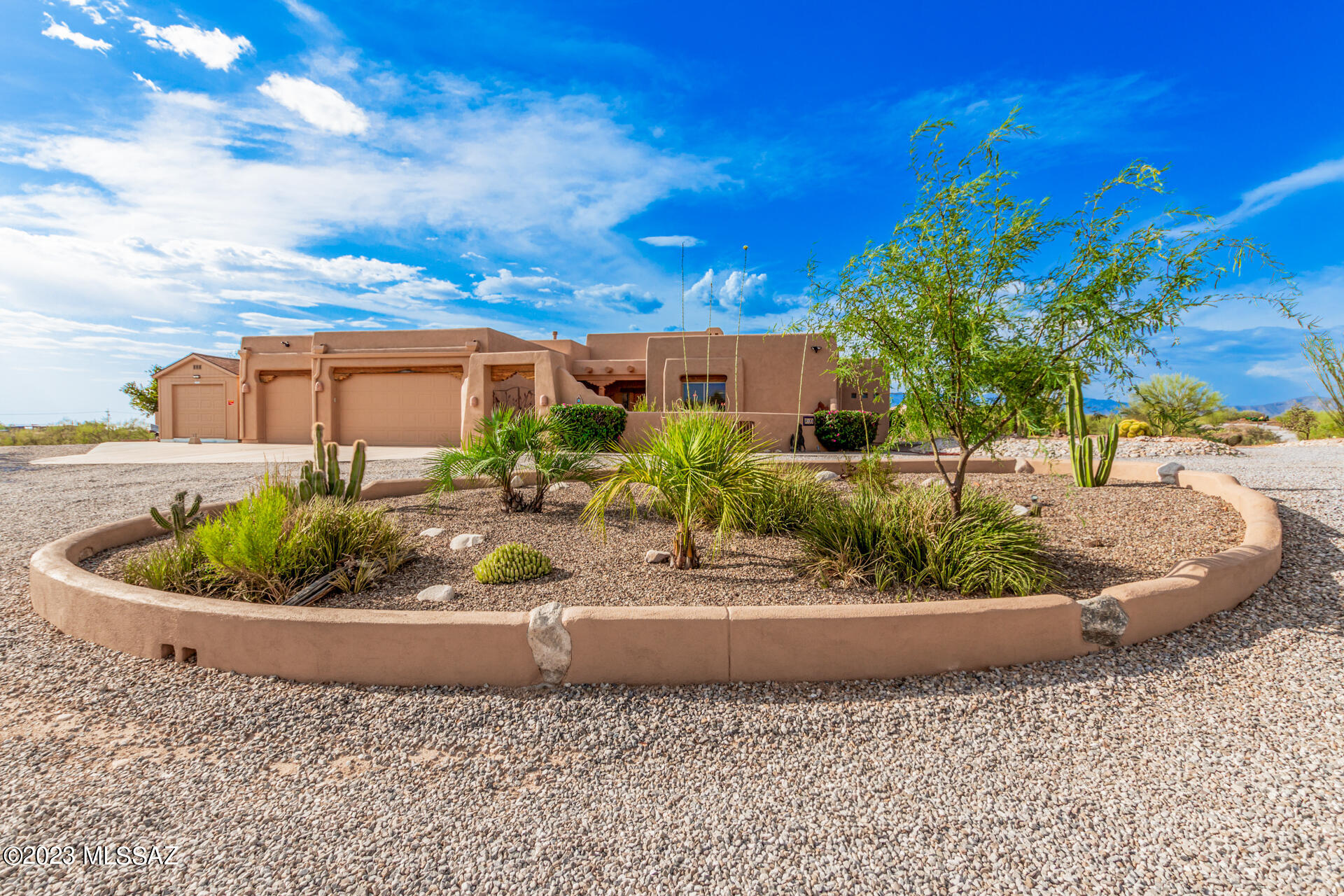 This meticulously maintained 3.73-acre property is nestled amidst private streets and exquisitely framed by a striking desert landscape. A grand circular driveway, a generous 3-car garage, and a secure gated courtyard provide an inviting introduction to this impressive estate. The home unfolds into an open layout that exhibits high ceilings, rustic exposed hand carved wood beams, and custom tile flooring, offering an atmosphere of elegant comfort. A charming fireplace serves as the centerpiece, adding a touch of warmth and character. The gourmet kitchen has upscale design, high end features and and function throughout. Sleek granite counters, custom tile backsplash, and custom paneled cabinets with crown moulding to create a refined aesthetic. High-end Viking stainless steel appliances, a built in ice maker, a convenient dry bar, a walk-in pantry, and an island with a breakfast bar amplify the space's functionality. Within the kitchen and great room is a built in quaint office space ideal for working from home. The main bedroom is a serene sanctuary featuring french doors open to the backyard for indoor-outdoor living. A roomy walk-in closet caters to your storage needs, while the private bathroom boasts dual sinks, a walk in shower and a jetted tub, delivering convenience and luxury. Enjoy majestic sunsets in the sprawling backyard, an outdoor paradise providing breathtaking mountain views and a wealth of amenities. An outdoor kitchen, built in pizza oven and a cozy fireplace create the perfect setting for entertaining. The covered ramada and gazebo offer shaded relaxing areas throughout, while the sparkling pool invites you to take a refreshing dip. Mature vegetation, fruit trees, desert landscape and your own little paradise. Don't miss this incredible home! Call listing agent for an appointment. (By Appointment ONLY)
