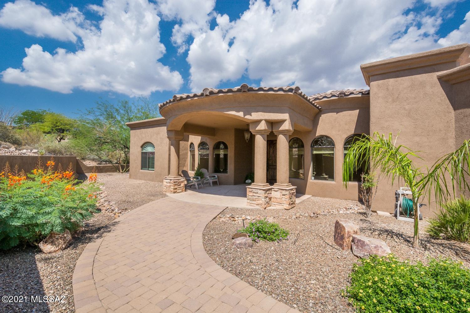 SOPHISTICATED & CONTEMPORARY BEAUTIFUL HOME WITH OUTSTANDING VIEWS AT THE BASE OF THE TUCSON MOUNTAINS. DESIRABLE GATED ENCLAVE OF CUSTOM HOMES IN LOS AORROYES DEL OESTE COMMUNITY. GREAT SPLIT BEDROOM FLOORPLAN,  UPGRADES INCLUDE, TRAVERTINE & WOOD FLOORING, DESIGNER PAINT THROUGHOUT, SURROUND SOUND EXTRA STORAGE AND SOLID WOOD DOORS. OPEN KITCHEN FEATURES, HUGE ISLAND, GRANITE CTPS, SS APPLIANCES, PREP SINK, BREAKFAST BAR & NOOK. GREAT ROOM WITH GAS FIREPLACE AND SEPARATE FORMAL DINING ROOM. 2 WALK IN PANTRY ROOMS. CUSTOM ALDER CABINETS AND LOTS OF STORAGE. SEPARATE DEN/ OFFICE ROOM OR 5TH BDR. 3  BEDROOMS ON OPPOSITE SIDE OF THE  MASTER SUITE WHICH INCLUDES A PRIVATE READING/SITTING ROOM AND ADDITIONAL 2ND BATHROOM. ENCLOSED FRONTYARD WITH PRIVATE COURTYARD. EXTENDED BACK PATIO. VIEWS!!