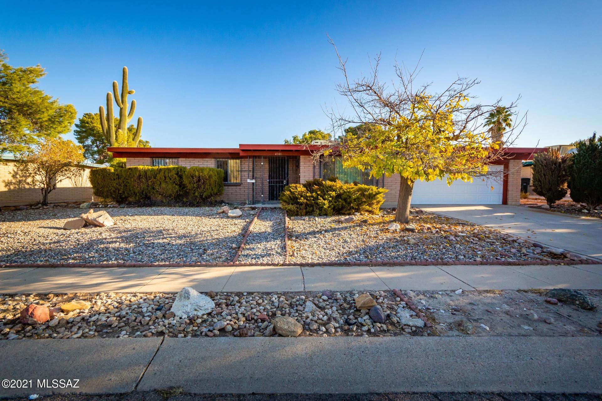 Fantastic Mid-Century Modern home w/great curb appeal & a large backyard. Plush carpet, crisp palette, window blinds, ceiling fans, & patio access from dining area.  Plenty of wood kitchen cabinets, undermount sink, & corian counters. Impressive stone fireplace in the family room. Generous size bedrooms, ample closets, 2 pristine baths, & laundry area in the garage. Covered patio & room for a pool or garden! take a tour today & stop renting!