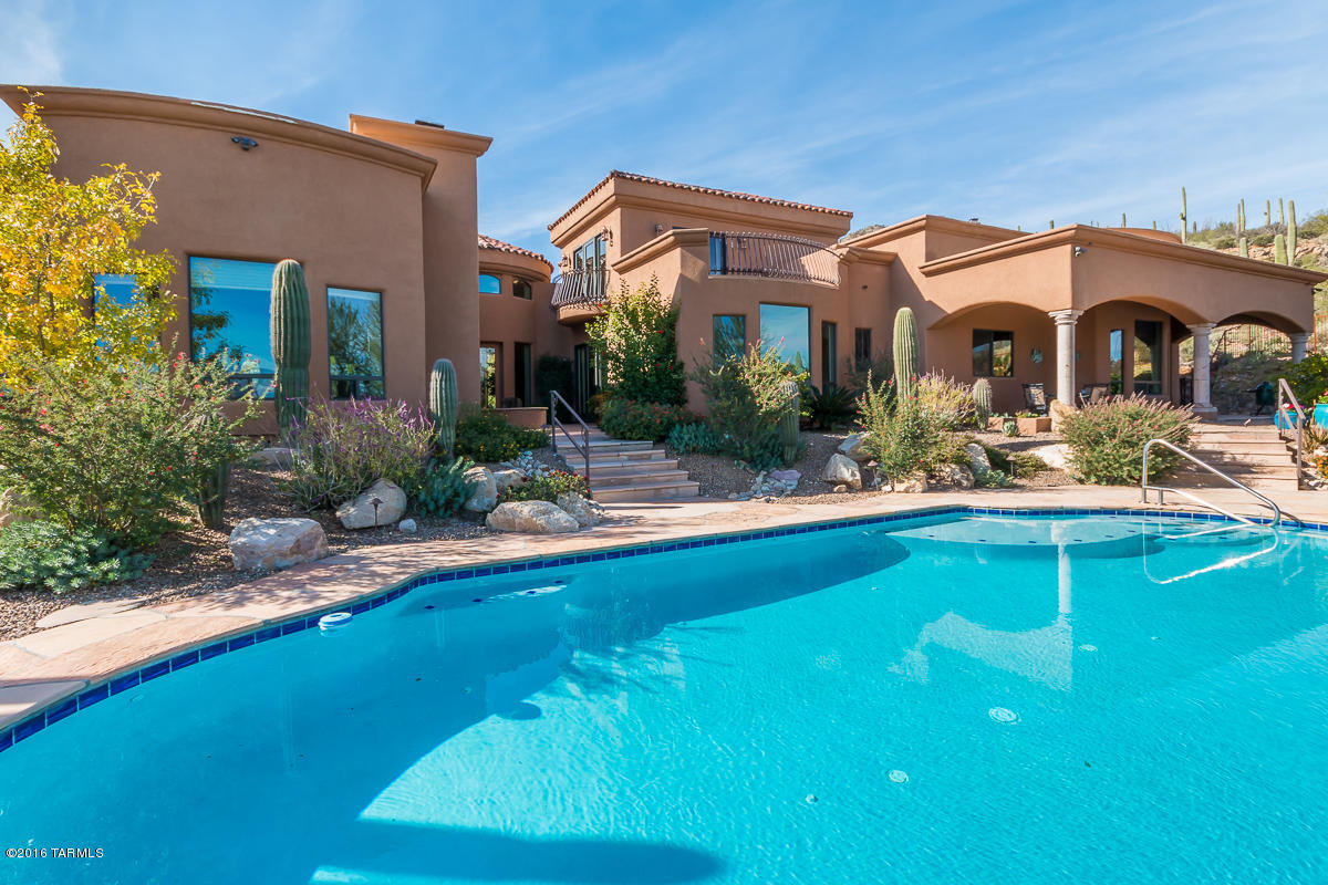 Overlooking the entire Tucson Valley, this listing offers BOTH a stunning custom Mediterranean home AND an unbelievable view of 1,000 saguaros, city lights and Catalina/Rincon mtns.  What you see + how you feel = Living Well in the Desert! Private acreage below protects your view! Mere minutes away is the University of Arizona, a vibrant downtown offering professional and collegiate cultural events, many restaurants, and nationally recognized medical facilities such as Banner/U of A Hospital.superb hiking, and world famous Desert Museum.  Soaring high ceilings, Solar power, Central Vac, Granite Counters, 2 Dishwashers, Double Ovens, 5-burner Monogram Gas Stove, travertine tile, water softener, 36'' Doors, 3 Fireplaces incl master!, fully Fenced, Gated, Security System,..WHEW! TRULY AWESOME features views from nearly every window, granite countertops, travertine throughout and upgrades everywhere you look.  This home offers tranquility, and an opportunity to relax, refresh and revive.... Truly a home to be proud of!