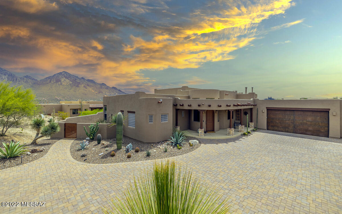 Sophisticated Oro Valley living in this stunning and well-kept SW Custom on 3/4 acre lot. Amenities: Split floor plan, polished concrete floors, upgraded tile and granite features, remote window shades, den/office,  and oversized 3 car garage. Exterior features include paver drive and patios, secluded yard with solar-heated saltwater pebble-tec pool, hot tub and putting green, all with spectacular mountain/city views. Just a short drive to the Oro Valley BASIS School, Oro Valley Aquatic Center, James Kreigh Town Park.