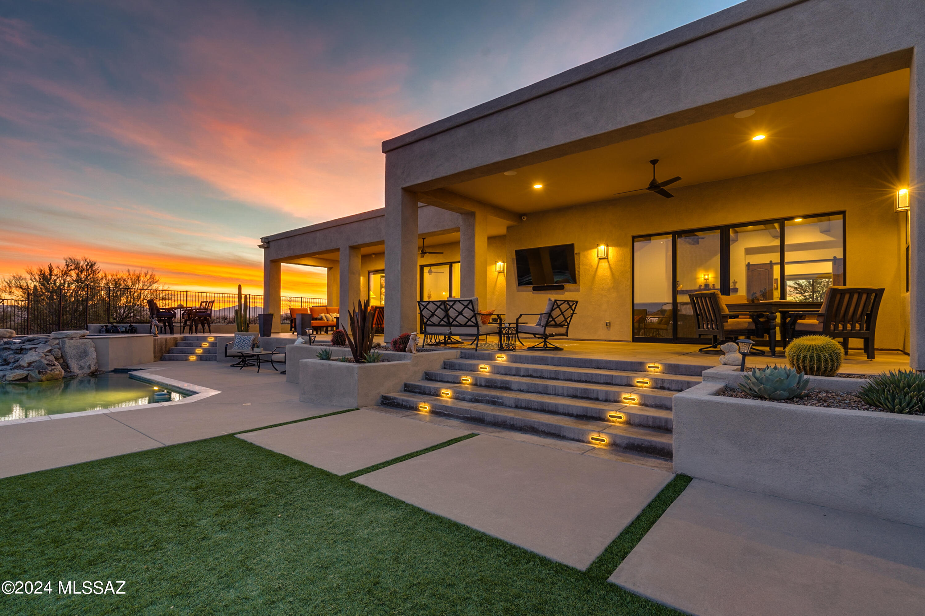 Upon arrival you will note the captivating attention to detail of the six acre home starting with the pavers that lead up to the cantilever glass front door welcoming you to the ambiance of enjoyment. Custom home offering affluence in all the right areas. Enjoy sunsets, or watching the game from the large outdoor TV from your extended patio. Sip your favorite beverage curled up watching the fire from either your bedroom or the living room. Ready for your workout? Relish in your home gym, followed up by a soak in the hot tub, steam or take a swim in the pool. Savor all this luxury home has to offer; VSSL surround system, steam shower, temperature-controlled wine closet, central vac, plus a 3-car garage. Come enjoy so much of what this home has to offer! Upon arrival you will note the captivating attention to detail with the pavers that extend all the way from the road.  You will enter through the 10' cantilever glass front door which welcomes you to the ambiance of enjoyment.  This custom home offers affluence in all the right areas with a split floor plan.  The guest en-suite is positioned at the front of the home with its own separate door to the back patio which overlooks your private desert views. Enjoy your favorite tunes with the outdoor surround sound VSSL system.  While soaking in the spa to watch the sunsets or swimming in the pool the tranquility will not disappoint.  The oversized covered patio presents a fantastic opportunity for outdoor tv viewing and dining al fresco.  If you prefer to retire indoors for more relaxation turn on the two-sided fireplace to warm you on those chilly evenings in your private bedroom sitting area or in the main living quarters. The primary bedroom automated blinds are controlled by a remote no need to climb out of bed to manually open the blinds that look out to the beautiful Catalina Mountains.  Imagine creating a delicious meal in the well designed gourmet kitchen equipped with a pot filler, 2 ovens and 2 sinks.  Delight in all the glory of this magnificent kitchen from the views of Catalina Mountains to the Tucson city lights.  Featuring quartz countertops, walk-in pantry, additional pull out pantry, pot filler and high end appliances.  There is no shortage for storage in this home all cabinets and drawers are soft close.  The oversized laundry room also has a built in ironing station equipped with electrical outlets and a sink with quartz countertops. Ready for your workout?  Relish in your own home gym with its own split unit.  The convenient remote allows you to regulate the temperature as you workout.  Need to relax your muscles after a good workout, no problem the spacious primary bathroom shower accommodates that need.  The jack & Jill bedrooms also have automated blinds and remotes, each have their own private separate vanity areas.  These rooms as well as the office are graced with views highlighting the colors of Tucson sunsets.  The luxury in this amazing home continues with interior surround sound, ceiling fans throughout even patio ceiling fans and remotes, central vac indoors as well as in the garage, solid 8' wood doors throughout, temperature controlled wine closet for the wine enthusiasts, sky lights positioned strategically to take advantage of all the natural light.   This unique custom home in Oro Valley is close to restaurants and retail yet allows you to revel in your privacy on over 6 acres.