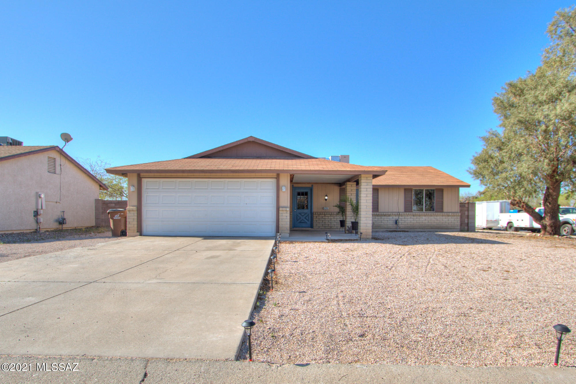 Welcome Home!!! You must see this gorgeous 3 bed 2 bath home in the Casa del Oeste community conveniently located off Ina and I-10. Freshly painted and tile throughout with a contemporary vibe. Updated kitchen with new cabinets, countertops, stainless-steel Frigidaire refrigerator, stove and microwave. Large entertaining area with wood-burning fireplace. Spacious master with en-suite – both bathrooms have been updated with new vanities, lighting, shower enclosure, and hardware. This home is in the Marana school district with easy access to a variety of shopping, restaurants, and services. Large corner lot that you can make your own!