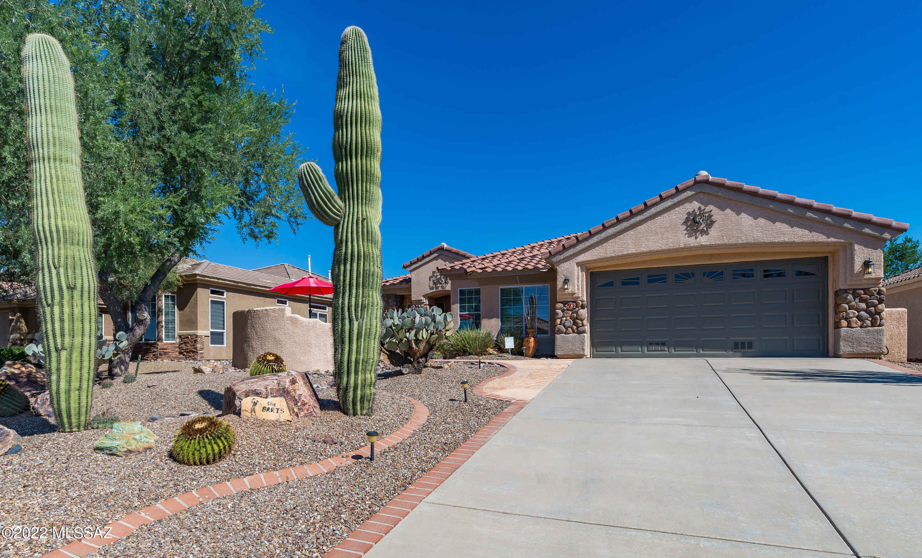 Stunningly beautiful, extremely well kept customized Tahoe model w/extended garage and golf cart alcove parking. Garage is so nicely extended that one can park your vehicle and still pull the golf cart in without extra maneuvering. Relaxing backyard with gas fireplace, built in BBQ area, fully fenced yard and outstanding golf course views and Tortolia Mountain views. This is a very peaceful location. Lengthy driveway is also a plus. Custom doors to den/office area w/nice courtyard view window - and beautiful pergola wood floors. Lush high end carpet in both bedrooms - tile flooring throughout rest of home. All kitchen and laundry room appliances convey w/accepted offer. Abundant storage throughout home. Very nice home. Call for private showing.