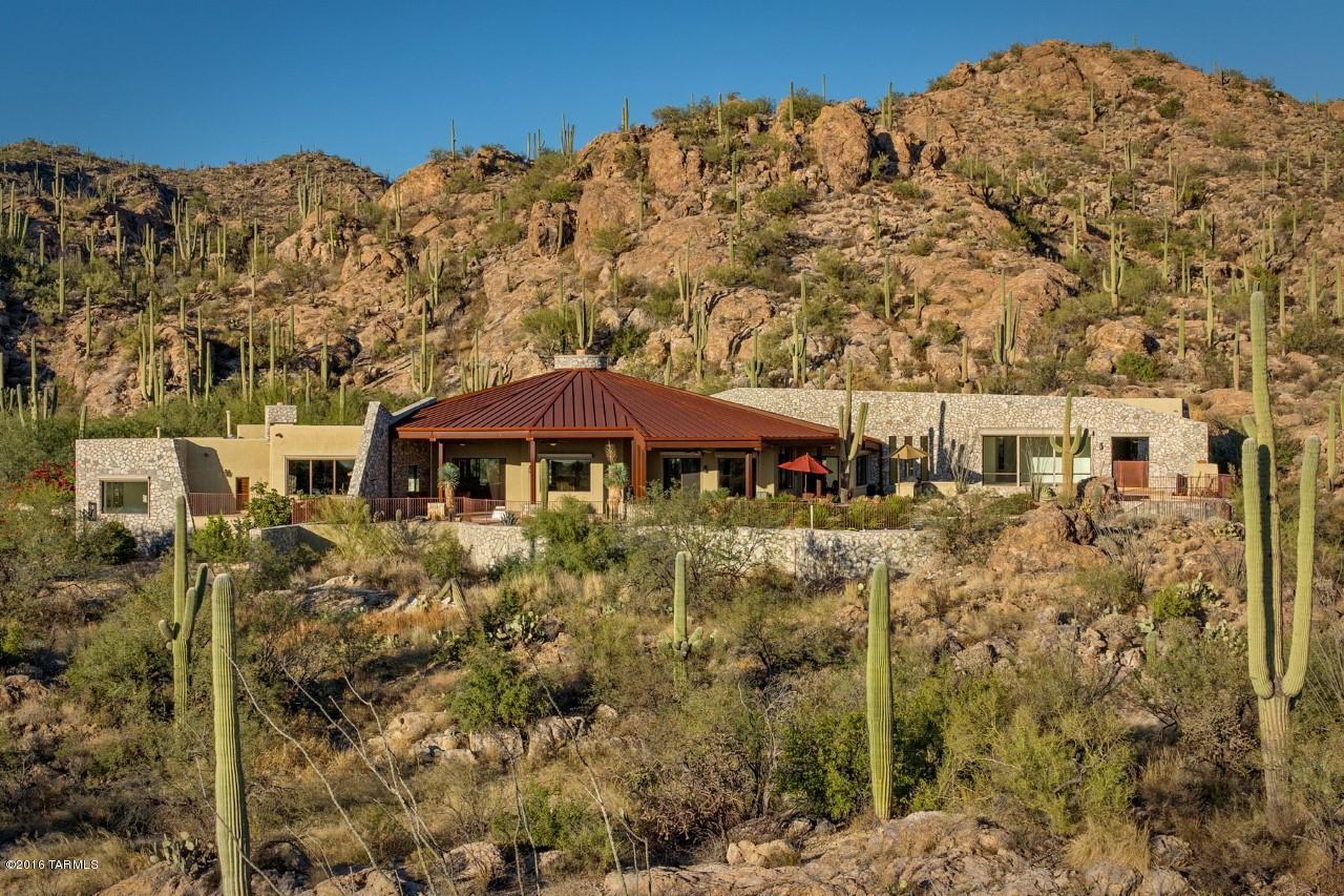 Designed for ''The Real Tucson Lifestyle.''  A Pristine Sanctuary  perfectly situated in a Saguaro Studded Canyon, embraced by the Coronado National Forest with Trailheads at your backdoor.  Strong, Modern Structure of Rock, Steel and Natural Materials beautifully integrates with the environment.  Majestic Desert Landscape extends into each and every room through Sprawling Patios and bands of Gorgeous Windows and Doors.  Large-scale Living Areas with a Grand Gourmet Kitchen at the Heart.  Elegant Den lined in Rich Wood Finishes and Rock Fireplace.  All 3 Guest Bedrooms Ensuite and an Oversized Master Bedroom Wing with Enormous Closets.   State of the Art Wine Room and Generous Storage.  Exceptional Quality, Craftsmanship and Good Taste.  Prime Northeast Foothills - Just Minutes   to Town.